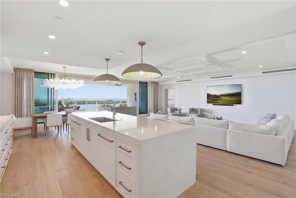 Discover timeless coastal elegance at Kalea Bay - Naples' most prestigious waterfront enclave.  This stunning home is in the most recently delivered Tower 4 - and in the ultra desirable, SW facing, 03 stack.  This sophisticated four-bedroom, four-and-a-half-bath condominium offers the perfect balance of refined living and breathtaking natural beauty. The expansive private balcony serves as the centerpiece of the home, delivering sweeping, unobstructed views across lush mangroves, the serene bay, and the shimmering Gulf beyond. Whether savoring morning coffee or sunset cocktails, this wrap-around outdoor sanctuary captures Southwest Florida’s most coveted vistas in every direction.  Generously proportioned and thoughtfully designed, the residence features over $140,0000 in upgrades including hurricane shutters, ceiling treatments, and custom closets designed in all rooms. Custom finishes like Visual Comfort lighting, designer drapery,  electric shades and a lighting control system elevate the space.  An  open, light-filled layout flows effortlessly, creating an ideal setting for both relaxed everyday living and gracious entertaining.The gourmet kitchen is a sophisticated statement with an oversized island, a Wolf & Sub Zero appliance package including a built in under counter refrigerator and full sized wine cooler.   Access to Kalea Bay’s private gated entrance ensures peace of mind and the promise of an uncomplicated lock-and-leave lifestyle with 24-hour manned security and on-site management. Included membership to the Kalea Bay Club unlocks a world of five-star resort amenities and experiences, including three pools, expansive decks, and two restaurants. Other Club amenities include a state-of-the-art clubhouse, a recently completed multi-million dollar Wellness Center, active tennis and pickleball programs, a teen lounge, kids’ game rooms, and salon.   Tower 4 is conveniently located directly across from The Club - the closest of all towers - adding to the value and desirability of T4.  If you dream of waking up to paradise every day with world-class amenities at your fingertips, look no further.  Parking is effortless with one dedicated assigned space and one floating space included with the unit — maximum convenience in this gated, resort-style community.   Residents enjoy the amenities of a true five-star resort: an awe-inspiring rooftop terrace and pool, a sprawling 100,000+ square-foot amenity center with clubhouse, wellness center, restaurants, pickleball courts, tennis, and so much more.
