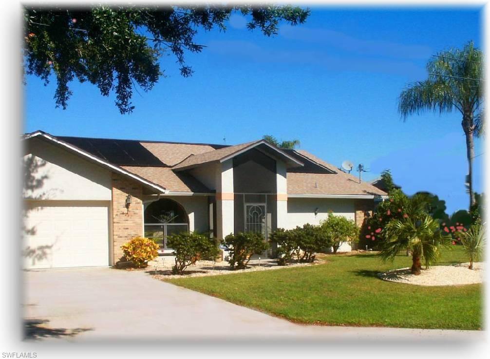 Own a piece of paradise with this spacious pool home located on a tranquil freshwater canal in an established, peaceful neighborhood.   This lovely home welcomes you with mature landscaping, [including tropical avocado, lime, and banana trees] a screened front entry & wooden double doors leading to the formal living & dining rooms with cathedral ceilings & tile floors throughout. The kitchen is the heart of the home with granite counter tops, an island & a casual dining area & is open to the family room. The private master suite features an en suite bathroom with dual sinks, a tiled shower & beautiful French doors leading to the screened lanai & pool area. Entertain guests on the oversized lanai with large, sparking solar heated pool or enjoy relaxing days fishing off of your private dock or boating to nearby Mohave Lake. City water & sewer are in & paid. Not in special flood zone so no flood insurance needed.   Call today for your personal tour!