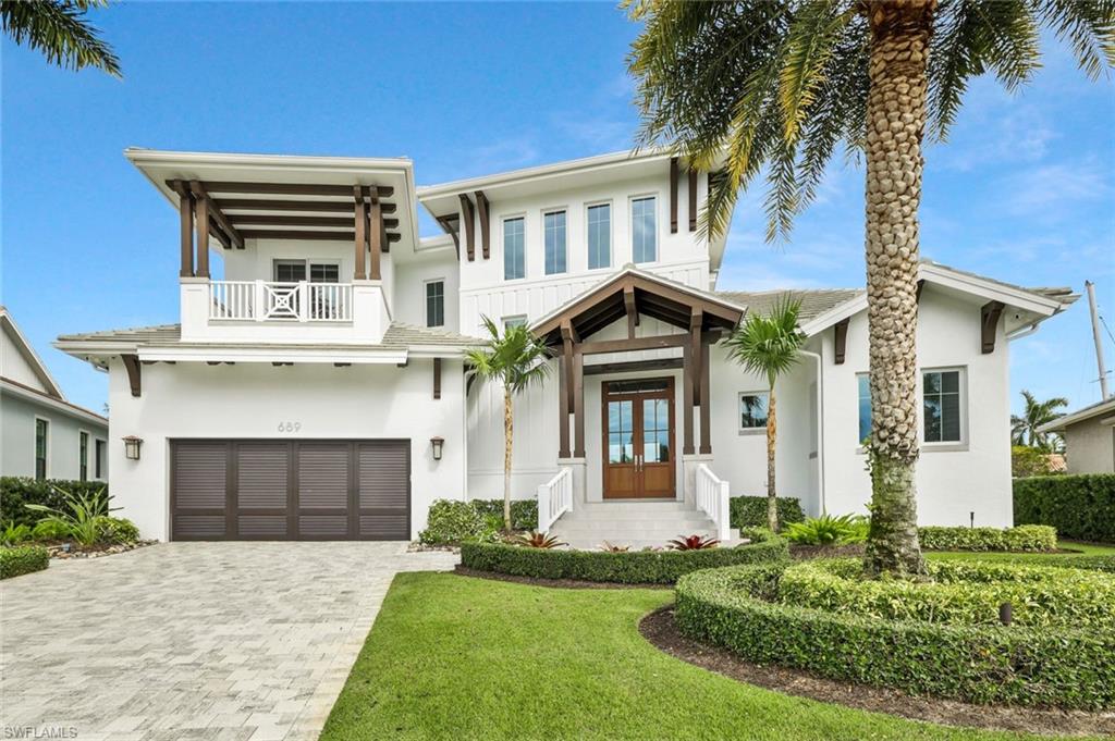 This coastal-inspired estate, built by Braun Builders, offers 5,437 sq ft under air and over 8,500 sq ft total, with 6 bedrooms and 4.5 baths. The furnished home is designed for entertaining and features refined finishes throughout including marble and hardwood floors, custom ceilings, built-ins, and Sub-Zero appliances. Enjoy expansive covered outdoor living spaces on both levels with retractable screens, an infinity-edge pool, firepit, and beautiful views of converging waterways. Additional highlights include an elevator, handicap accessibility, a 3-car garage with ceiling height to accommodate a car lift, and a private dock with two lifts. Ideally located on the south end of the island with quick, direct access to the 1000 Islands, and within walking distance to beach access at Collier and Winterberry, as well as Marco Island's premier dining at Marco Walk Plaza.