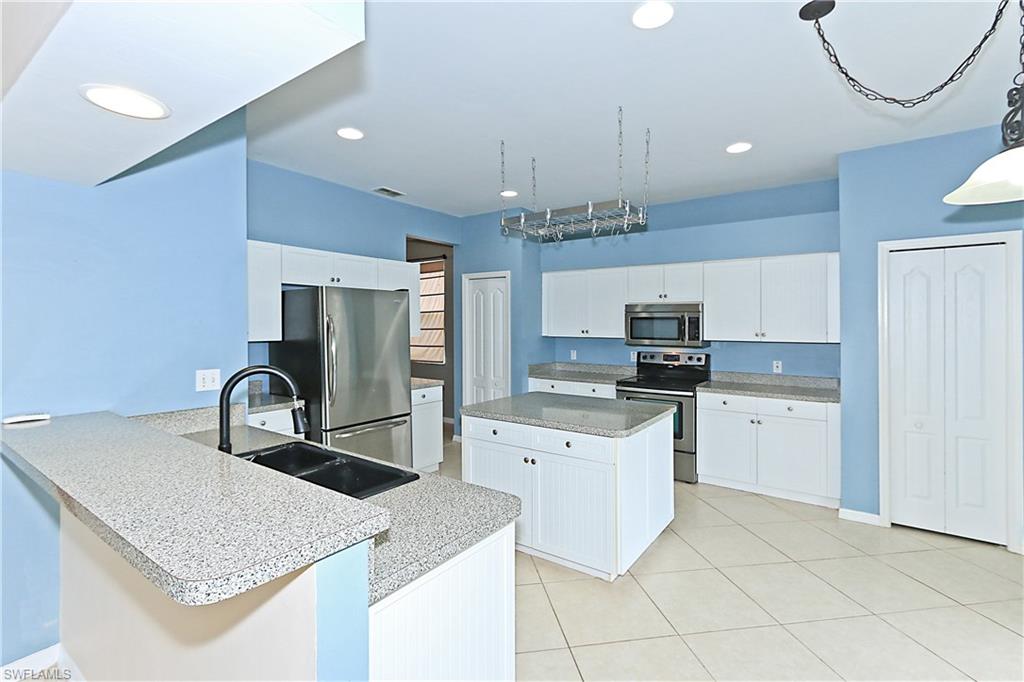BELOW APPRAISED VALUE! LARGE LAKEFRONT FAMILY HOME complete with new wood tile flooring on first floor, newer kitchen cabinets/stainless appliances, remodeled master bath, custom painted, and both a/c's installed in 2011. The first floor has 1 bedroom + 1/2 bath, spacious family room, large kitchen with island, 2 pantries, office, open floor plan dining room and living room.The second floor has 2 large guest bedrooms+ master, guest bath, renovated master bath, & master bed complete with walk in closet to die for! BRAND NEW CARPET THROUGHOUT THE 2ND FLOOR!  BEST LOCATION IN COMMUNITY closest street to walk to playground, A+ Pinewoods School, pool, playground, baseball/soccer fields, tennis courts! AND next to the back exit/entry gate! Enjoy lake views from your screened lanai/large backyard-plenty of room for a pool. STONEY BROOK: a family friendly gated community with golf course (pay as you play). LOCATION...LOCATION... minutes to I 75, Miramar Outlets, Germain Arena, Gulf Coast Towne Center, & FGCU. Walk to A+ Pinewoods Elementary School! LOW HOA FEES!  (If you have seen the house before-take another look, wall between dining/living room has been taken done + new carpet upstairs!