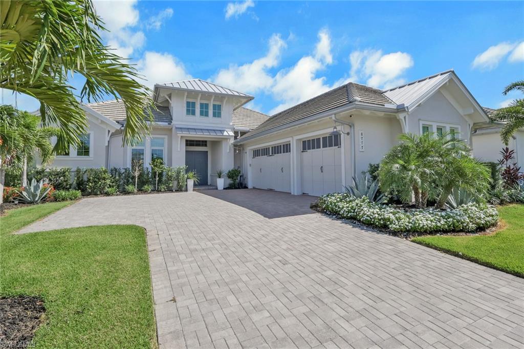 Experience the pinnacle of custom luxury at 8777 Santo Domingo Drive, a completely reimagined Madison II by Stock Development, positioned on one of the most coveted lots in Isles of Collier Preserve with breathtaking outdoor living & views being offered turnkey. This is not your builder's Madison II. Every inch has been rebuilt with an elevated vision using fully custom Porcelenosa cabinetry and tile, replacing builder-grade elements with a cohesive, luxury aesthetic. Spanning 3,054 sq. ft., this 4-bedroom plus study, 4.5-bath home features soaring ceilings, a dramatic casement entry with custom wallpaper and built-in TV console, custom closets, and a chef's kitchen with gas cooktop and a large custom island with double sided cabinets for storage and walk-in pantry, and four full ensuite bedrooms, including a poolside guest suite with private pool bath. Outside, a massive saltwater pool and spa, panoramic screen cage, fully equipped outdoor kitchen, and sprawling screened lanai capture stunning sunsets and serene water views overlooking the Botanical Gardens. Additional highlights include a 3-car air-conditioned epoxy garage, 1,000-gallon propane tank, gas pool heat, motorized shades, window treatments, impact windows and doors, custom landscaping, buried gutters, Level 5 smooth coat walls, sound system through great room, kitchen, dining, and lanai, and full smart home package among other standouts. The Isles of Collier Preserve is a private, gated community less than 5 miles from Old Naples' world-class dining, boutique shopping, and pristine Gulf beaches. Residents enjoy resort and lap pools, a state-of-the-art fitness center, 14 pickleball courts, 6 tennis courts, bocce, a dog park, over 8 miles of scenic trails, kayaking, paddleboarding, and the beloved waterfront Overlook Bar & Grill. This is Naples living at its absolute finest - don't miss out!