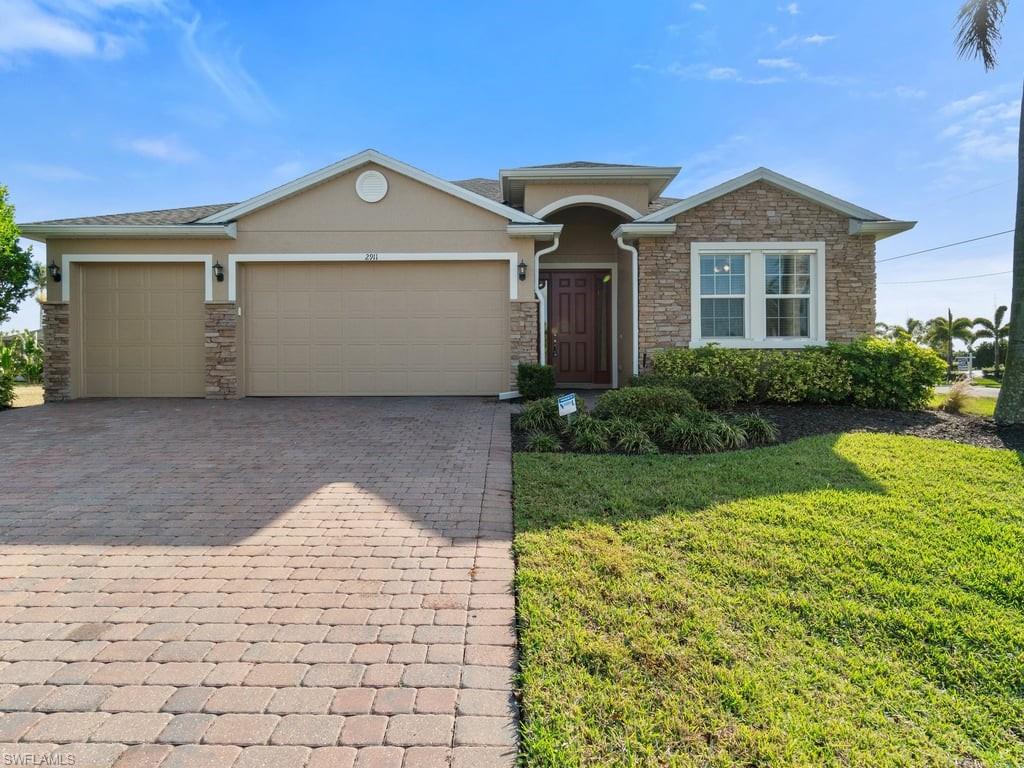 Welcome to your dream home in the highly desirable Surfside area of Cape Coral! This stunning 3-bedroom, 3-bathroom residence, with a spacious den that could easily be converted to a fourth bedroom, offers 2,333 square feet of modern living space. Built in 2017 and meticulously maintained, it feels like new with its fresh interior and exterior paint, a new roof installed in 2022, and a recently updated HVAC condenser in 2023. Additionally, the AC coil in the air handler was replaced just two years ago for improved efficiency. The heart of the home is the large open floor plan, seamlessly connecting the living, dining, and kitchen areas—perfect for entertaining or family gatherings. The kitchen boasts sleek stainless-steel appliances, granite countertops, a large pantry, and a functional center island that offers additional seating. The primary suite is an oasis of relaxation with dual walk-in closets, a luxurious soaking tub, a walk-in shower, dual sinks, and a private water closet. Step outside to enjoy the Florida lifestyle on your screened-in lanai, overlooking the large backyard with ample room for outdoor activities or even a future pool. Sitting on a corner lot, the property features a paver driveway leading to a generous 3-car garage. For added convenience, the garage includes a pull-down set of stairs leading to a plywood-floored attic, providing excellent extra storage space. Conveniently located near Veterans Parkway, this home is just minutes from top-rated schools, vibrant restaurants, premier shopping, and local parks. It’s ideal for families, retirees looking for a peaceful retreat, or young professionals seeking a central location with modern comfort. Don’t miss your chance to own this incredible property. Make this beautifully updated home yours today! Some Photos in this listing have been virtually rendered. Pool quote available for this home!