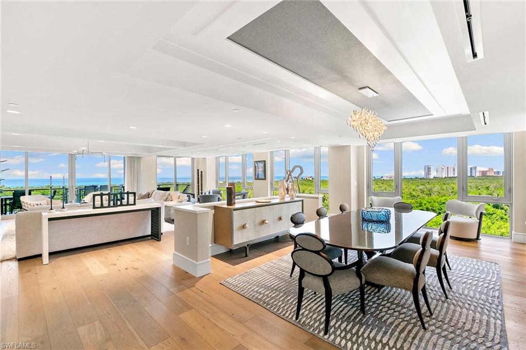 Rarely available end-unit condominium, offering forever unobstructed Gulf views from the entire side of the building, with floor-to-ceiling windows framing breathtaking views overlooking the Gulf. High above the Gulf, Mystique is the newest gem in Pelican Bay’s skyline, offering majestic vistas of the sparkling blue waters and mesmerizing sunsets. Recently reimagined by a renowned interior designer, this home showcases a refined design palette, blending luxury and tranquility in a spacious open floor plan, ideal for entertaining and relaxation. Enter into this exceptional residence and be welcomed by a series of refined finishes that exemplify casual elegance. The chef-inspired kitchen is outfitted with exquisite Carrara marble countertops, Wolf and Sub-Zero appliances, and sleek white cabinetry, while the beauty of Legno Bastone Italian wood floors flows throughout. The primary suite offers a private retreat with panoramic Gulf views from the bedroom and the spa-like bath. Complete with five-bedroom suites and abundant storage, this home is designed for comfortable living at every level. Includes EV charger. Mystique isn’t just about stunning aesthetics, it’s about an elevated lifestyle. Enjoy the convenience of 24/7 concierge services, making every need effortless. As a resident of Pelican Bay, you gain access to an array of world-class amenities including private beachfront dining, beach access with chair and umbrella service, tennis and pickleball courts, fitness center, and miles of scenic recreational and biking paths. Just minutes from Artis-Naples and upscale Waterside Shops, Mystique offers a balance of peaceful living and easy access to culture and shopping. Accept this invitation to experience a life of unparalleled luxury, beauty and convenience.