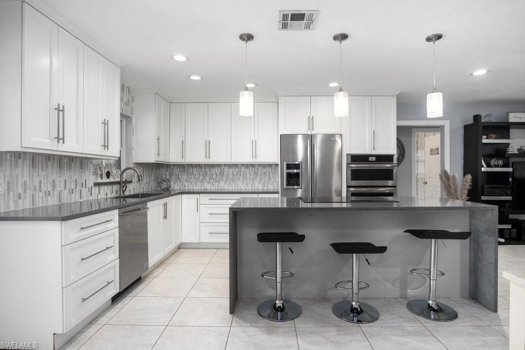 This INCREDIBLE centrally located Willoughby Acres 3-bedroom, 3 bath pool home with an upgraded custom dream kitchen, stainless steel appliances, quartz countertops, soft-close custom kitchen cabinets. All the bathrooms have been completely remodeled with designer tile, custom cabinetry, upgraded vanities. In addition to the three Bedrooms and three Bathrooms, there's an Office/Den that allows you to work right from home and close enough to jump right into your stunning Pool with a screened Lanai which features an amazing built-in tiki. This home had a New Roof in installed in 2016, impact windows. Fenced in back yard with plenty of shade will allow you to Enjoy this home with NO HOA fees. Approximately 4 miles to the beach, and in close proximity to shopping and dining make this home a MUST SEE!