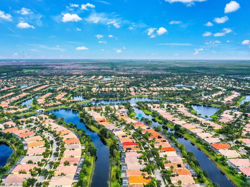 NEW PRICE! This light and bright three-bedroom plus den single-family home is ready for you and located in the sought-after Village Walk of Bonita Springs, a private, gated community offering a vibrant resort-style lifestyle. Situated on a desirable lakefront homesite with eastern exposure, this Oakmont floor plan features a spacious covered lanai with a private heated pool, ideal for morning sun and lake views. Crafted with quality DiVosta poured concrete construction, the home includes a NEWER ROOF, ceramic tile flooring in the main living areas, crown molding, a laundry room with utility sink, and an attached two-car garage. The thoughtfully designed layout offers multiple living and entertaining areas, while the den provides flexible use as a home office, hobby space, or guest room. The owner's suite includes a large walk-in closet and en-suite bath with dual sinks for added comfort and functionality. A newer air conditioning system enhances energy efficiency. Select furnishings are negotiable. Go outside to the screen-enclosed lanai and enjoy peaceful mornings by the pool or casual outdoor dining with lake views and fresh breezes. Lawn care, irrigation, high-speed internet, and cable TV are included in the HOA, offering convenience and peace of mind. Residents of Village Walk enjoy a wide array of amenities at the beautifully designed Town Center, including a full-service restaurant, bagel shop, touchless car wash, gas station, post office, beauty salon, hair spa, and wellness services. Recreational options include Har-Tru tennis courts, pickleball, bocce, basketball, a 24-hour fitness center, playground, and both resort-style and lap pools. A full-time lifestyle director coordinates social events, fitness classes, and neighborhood gatherings that foster a welcoming community. The neighborhood is surrounded by scenic lakes and charming Venetian-style bridges, with miles of walking and biking paths, butterfly gardens, and lush landscaping offering a serene, enriching environment. Residents enjoy walks by the waterways, clubhouse events and evenings in thoughtfully designed outdoor spaces. Ideally located in Bonita Springs, Village Walk offers easy access to Naples, Estero, and South Fort Myers. Enjoy proximity to white-sand Gulf beaches, Southwest Florida International Airport (RSW), and destinations like Coconut Point, Mercato, Gulf Coast Town Center, the Promenade, and Miromar Outlets. Local parks, preserves, golf courses, art galleries, cultural events, farmers markets, and waterfront dining are just minutes away. This exceptional home offers comfort, style, convenience, and connection in a thriving community designed for ease, well-being, and enjoyment. You’ll want to see this one first and experience the Village Walk lifestyle—where everyday living feels like a vacation. This is a rare opportunity to own a spacious home in a desirable community—where quality construction meets comfort and convenience.  You'll want to see this one first!