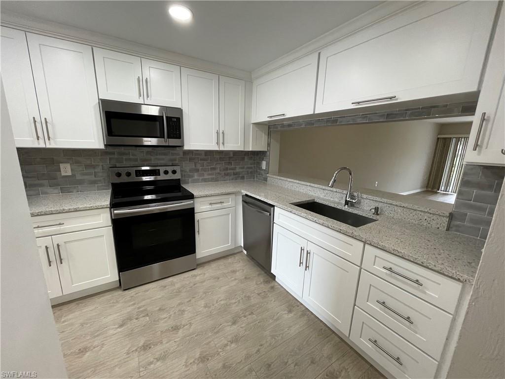 Welcome to the Annual Rental - 2/2 Condo in Abbey at Berkshire Village, a stunningly remodeled first-floor condo located in the heart of Naples, FL. This condo boasts two spacious bedrooms and two beautifully remodeled bathrooms, featuring marble-like tile work, white cabinets, and quartz counters. The split bedroom floor plan ensures privacy, while the large living room provides ample space for relaxation and entertainment. The condo is adorned with new wood plank vinyl flooring throughout, adding a touch of elegance to the overall aesthetic. The kitchen is a chef's dream, equipped with quartz countertops, stainless steel appliances, and white shaker cabinets. The condo also features a spacious walk-in closet for all your storage needs. Step outside to a large screened and covered lanai, offering a serene pool view - a perfect spot for your morning coffee or evening relaxation. The community pool is just a few steps away, ready for your enjoyment. Additionally, the convenience of having a laundry unit within the condo adds to the overall comfort and ease of living. Experience the perfect blend of luxury and comfort in this gorgeous condo at Abbey at Berkshire Village.