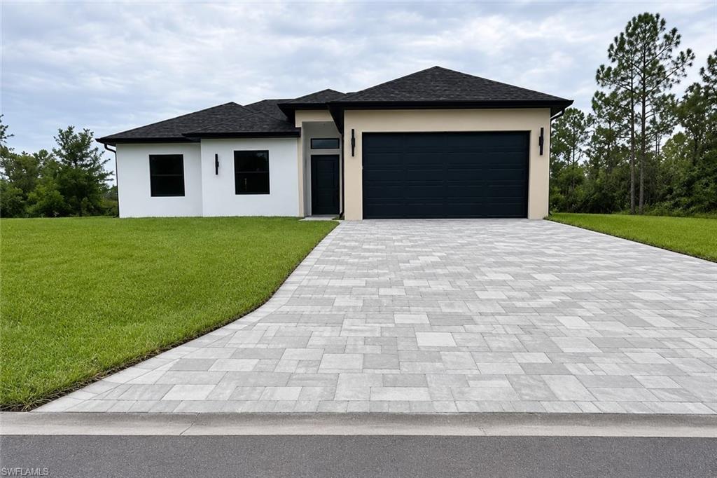 Welcome to this beautiful 3-bedroom, 2-bath home in the heart of Lehigh Acres, offering the perfect blend of comfort, style, and functionality. Designed with an open-concept floor plan, this home provides spacious living areas that flow seamlessly into the kitchen and dining spaces, making it ideal for entertaining or everyday living. Step outside to a large open lanai featuring a fully equipped outdoor kitchen, perfect for enjoying Florida’s year-round sunshine with family and friends. The fully fenced backyard offers privacy and plenty of space for pets, play, or future additions. This property includes a well water system with irrigation to help maintain the landscaping while reducing utility costs. Situated on a paved road, the home also features a two-car garage with a durable epoxy floor finish and an attractive paver-style block driveway that enhances curb appeal. Don’t miss this exceptional opportunity to own a move-in-ready Florida home that truly has it all!