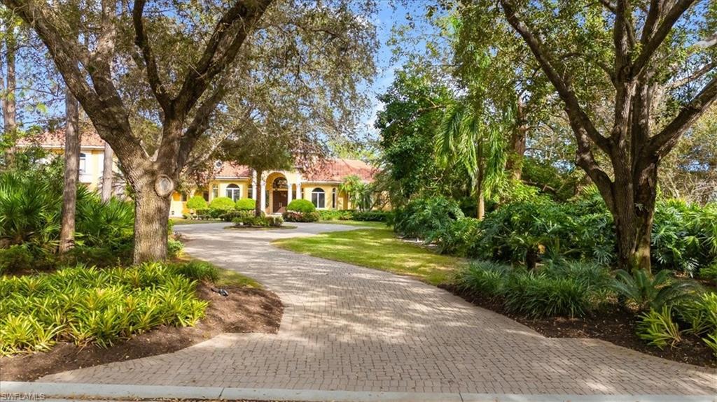 Nestled within the prestigious Grey Oaks community, 2737 Buckthorn Way is a true masterpiece, offering unparalleled elegance and breathtaking long water and fairway views. Set along a picturesque, tree-lined streetscape, this extraordinary property features a deep lot with a grand approach that invites endless possibilities for refinement or reimagining.

Spanning over 7,200 square feet, the residence boasts 7 bedrooms, 5 full baths, and 1 half bath, with soaring ceilings and an abundance of natural light throughout. From the moment you step into the foyer, your gaze is drawn to the stunning grotto pool and the serene water and fairway views beyond. The two-story windows in the fireplaced living room bathe the space in radiant sunlight, creating an atmosphere of warmth and sophistication.

Perfect for hosting, the home includes a formal dining room and a well-appointed butler’s pantry and bar. The chef’s kitchen and family room offer breathtaking views of the 5th hole of the Pine Course, with corner pocketing sliders that seamlessly transition to the expansive lanai, creating a seamless indoor-outdoor living experience.

The first floor includes three en suite bedrooms, including the luxurious owner’s suite with tall sliders opening to the pool and captivating views. A private study with built-ins and a versatile computer/game room add functionality and charm. Upstairs, four additional en suite bedrooms surround a vast unfinished space, ideal for a home theater, in-law apartment, or other creative uses. A sprawling covered veranda provides a serene vantage point to take in the tranquil pool, lake, and fairway.

The property also includes garage parking for four vehicles, with two bays attached to the main house and an additional two bays in a detached carriage house that features a workshop and ample storage.

Whether you choose to embrace the timeless elegance of the existing home or envision a new creation that takes full advantage of this exceptional site, 2737 Buckthorn Way offers limitless possibilities. This is more than a home—it’s an invitation to live your best life in one of Grey Oaks’ most spectacular locations.