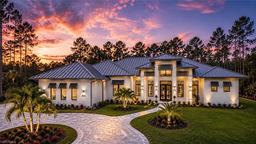 *Now fully furnished, updated and additional photos coming soon*. Experience elevated modern living in this newly constructed luxury estate situated on 2.73 acres of 100% upland in Logan Woods, surrounded by tranquil views, a circular driveway, and lush natural landscaping creating exceptional privacy and a true luxury retreat atmosphere.

The expansive open-concept floor plan is highlighted by dramatic tray and beam ceilings, oversized impact-resistant windows and doors, wood-look porcelain tile flooring, designer lighting, and a built-in wet bar complete with a wine cooler and illuminated floating shelving. The main living area centers around a sleek modern fireplace and flows effortlessly into the gourmet kitchen and outdoor entertaining spaces.

Designed to impress, the chef’s kitchen features custom floor-to-ceiling cabinetry with illuminated glass display cabinets, a premium Fisher & Paykel appliance package, double wall ovens, a gas cooktop with pot filler, quartz countertops, and a massive waterfall island. An oversized pantry, mud room, and spacious laundry room with abundant cabinetry and workspace provide additional functionality.

The primary suite offers a true spa-like experience with oversized dual vanities, a walk-in shower with dual rainfall shower heads, a freestanding soaking tub, private water closet with smart toilet, and a spectacular boutique-style custom walk-in closet complete with a center island and built-in storage.

Step outside into your private resort-style oasis featuring a panoramic screened-in pool and spa with a sun shelf, water features, outdoor fireplace, and a fully equipped summer kitchen designed for year-round entertaining.

Additional upgrades include a metal roof, tankless water heater, whole-house reverse osmosis system, spacious guest suites, and flexible living spaces ideal for an office or additional bedroom use.

Located just minutes from Naples shopping, dining, schools, and beaches, this exceptional property delivers luxury estate living with the privacy, flexibility, and space Logan Woods is known for — all with no HOA restrictions.