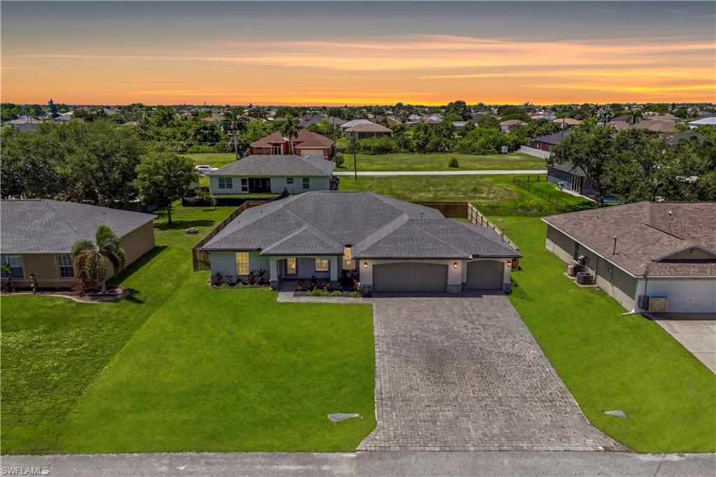 There's something special about a home that feels welcoming the moment you arrive and this one delivers that feeling from the very first step inside. Built in 2021 and beautifully maintained, this charming 4-bedroom, 2-bath residence offers the perfect blend of modern comfort, thoughtful design, and the relaxed Florida lifestyle you've been searching for. The open-concept floor plan creates a warm and inviting atmosphere filled with natural light, making it easy to gather with family and friends. Whether you're preparing meals in the spacious kitchen, enjoying morning coffee at the breakfast bar, or hosting unforgettable dinners in the dining and living areas, every space was designed for connection, comfort, and everyday enjoyment. The desirable split-bedroom layout provides privacy for everyone, with a peaceful primary suite featuring a walk-in closet and private en-suite bath. Three additional bedrooms offer flexibility for family, guests, a home office, or whatever your lifestyle may require. Step outside and discover your own private backyard retreat. The fully fenced backyard provides privacy, security, and endless possibilities for outdoor enjoyment. With desirable southern rear exposure, the yard is filled with beautiful Florida sunshine throughout the day and offers plenty of space to create the oasis you've always imagined. Design your dream pool, add lush tropical landscaping, create an outdoor kitchen, or build the perfect space for entertaining—there is room to bring your vision to life. Located in one of Northwest Cape Coral's fastest-growing communities, this home offers the convenience of nearby shopping, dining, parks, schools, and easy access to all that Southwest Florida has to offer. Enjoy the peace of a residential neighborhood with the added benefit of no HOA fees. More than just a house, this is a place where memories are made, gatherings are enjoyed, and every day feels like home. With modern construction, a private fenced yard, and room to create your ultimate outdoor lifestyle, this beautiful property is ready for its next chapter. All that's missing is you.