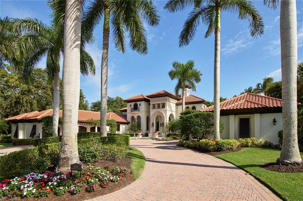 This custom-built well maintained estate resides in the Estuary at Grey Oaks on a premier homesite with an incredibly private panoramic lake, green and long-range golf course and preserve view. Its over 8,400 square feet of elegant living area has five bedrooms and five-and-a-half baths plus a wood-paneled study and second-floor game room. The moment you enter the home through the large mahogany front entry door the custom detailing is evident throughout including the two-story living room with coffered ceiling complete with a gas stone fireplace. The incredible outdoor living space consists of a freeform pool with spa and stacked-stone waterfall, a spacious covered living area with a gas fireplace, bar and outdoor kitchen. Additional features include a newer roof, neutral stone floors and rich wide plank flooring throughout main living areas, climate-controlled wine room, home theater, second-floor sitting area and laundry, five-car climate-controlled garage and a private elevator. A world of luxury awaits you in the award-winning Grey Oaks Country Club community just minutes from Naples' world-class amenities.