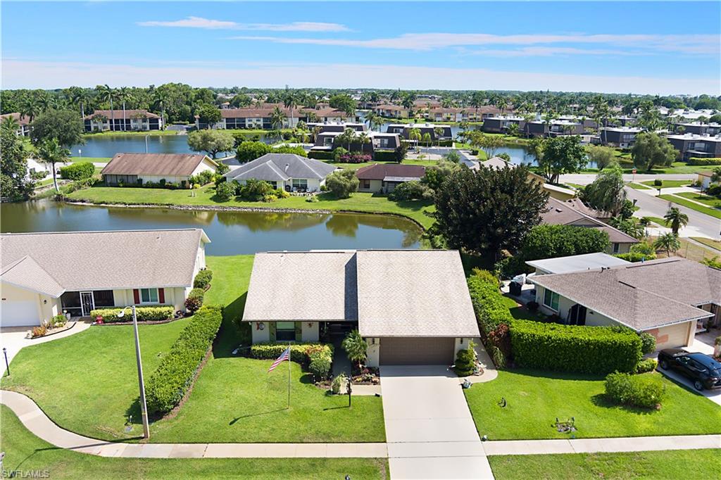 Tucked away on a quiet cul-de-sac with a beautiful lake view, this spotless 2-bedroom, 2-bath home in Riviera Golf Estates is one of those rare finds that checks every box. From the moment you arrive, the sweeping covered front entry with elegant French doors and a charming walkway to the rear of the home sets a tone that carries throughout. The living area is open and comfortable with luxury vinyl flooring, designer crown moldings, a coat closet near the entry, and a wonderful view straight through to the lake just beyond the Florida Room. The kitchen is beautifully done with neutral wood cabinetry, double pantries, a tray ceiling, stainless steel appliances, and granite countertops. The main suite is a peaceful retreat with a large walk-in closet, laminate flooring, and a stunning lakefront view to wake up to every morning. The en-suite bath features a walk-in shower, neutral tile flooring, and granite countertops. The Florida Room is the heart of the home — wall-to-wall windows frame the lake and flood the space with natural light, making it the perfect spot to start your day or simply sit and enjoy the view. The guest bedroom is generously sized with laminate flooring, crown moldings, and dual reach-in closets with built-in shelving that works beautifully as a home office or workspace. The guest bath offers a tub/shower combination, upgraded tile, marble countertops, and luxury vinyl flooring. The laundry room is large with a newer washer and dryer, and the 2-car garage has epoxy flooring with plenty of storage space. Impact glass is on all windows except the Florida Room. Riviera Golf Estates is a well-established 55+ community with one of the lowest HOA fees in Naples at just $145 a month, which includes basic internet. Community amenities include a brand new heated pool, 2 tennis courts that convert to 6 pickleball courts, bocce, shuffleboard, a fitness center, billiards room, library, and a large clubhouse with a busy social calendar. Just minutes away is the USOP National Pickleball Center on Thomasson Drive — home of the US Open Pickleball Championships and one of the top pickleball destinations in the country with 65 courts, clinics, leagues, and tournaments year-round. Downtown Naples, 5th Avenue dining and shopping, and the Gulf beaches are all a short drive away.
