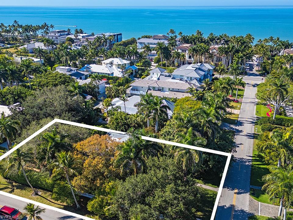 An extraordinary opportunity just moments from powder-white Gulf beaches and iconic Fifth Avenue South. Ideally positioned in the heart of Old Naples, this exceptional property offers both legacy charm and future potential. Just two blocks from the beach and four blocks from Fifth Avenue South, this rare corner lot sits only five homes from the Gulf. While offered at land value, the home itself is a gracious and substantial structure set on a beautifully proportioned, south-facing parcel. Elaborate English gardens and mature trees create a private, serene setting, along with convenient rear alley access. Freshly painted and featuring a newer roof (1997), this Old Naples home presents a remarkable opportunity to enjoy as-is, reimagine, or create an estate in one of Naples’ most coveted locations. A survey is available.