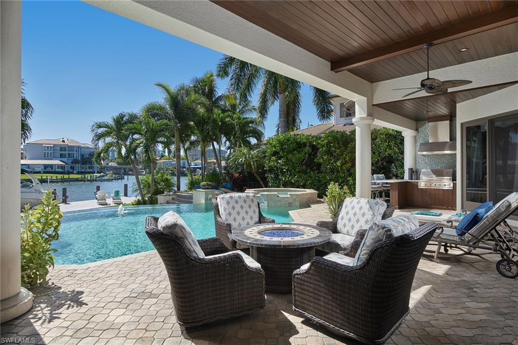 Southwestern views of Venetian Bay glisten as the sun begins to set beyond the high-rises, providing the perfect atmosphere to enjoy your piece of Naples paradise. Continually upgraded, this Park Shore gem has a new seawall and dock as of 2019, upgraded - impact windows and doors, custom shutter for the crystal-clear formal living room window, impressive Mahogany garage doors and recently improved kitchen with wine room. The 5-bedroom + den floor plan is ideally laid out with the master and 2 guest suites on the first floor, plenty of gathering space throughout and a gracious covered outdoor area with a summer kitchen. Located on the highly sought-after Turtle Hatch Road with quick and convenient access to Venetian Village and the Park Shore Beach Park, optional to join, this is not one you want to miss.
