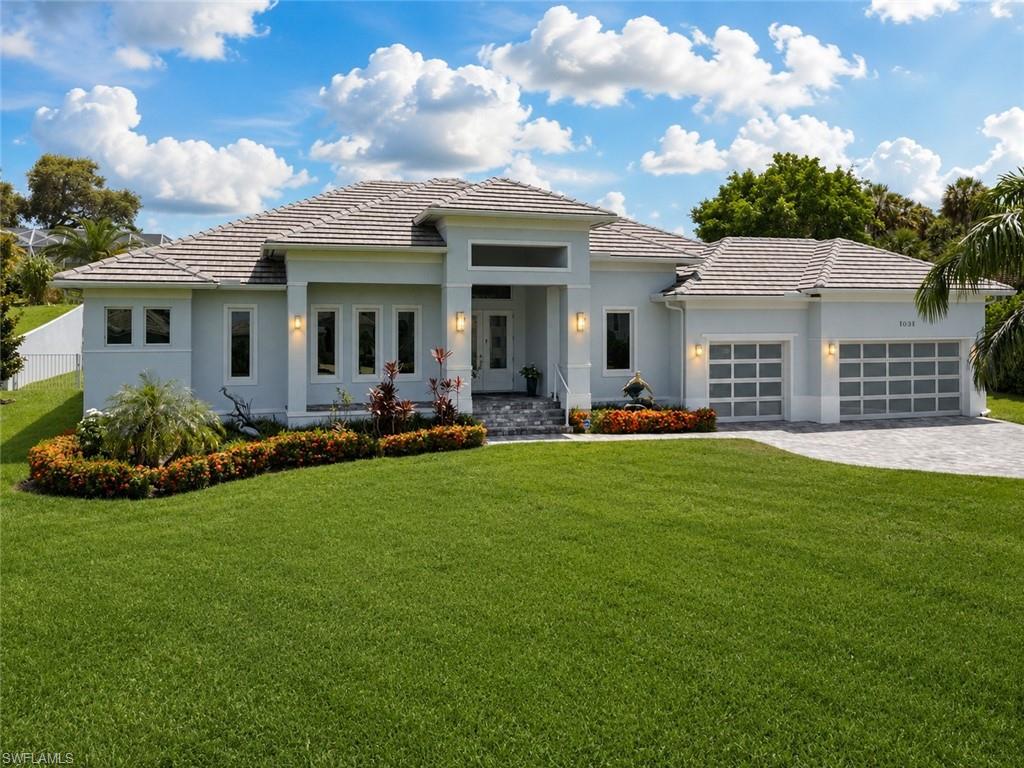 LOWEST PRICED NEWER CONSTRUCTION SINGLE FAMILY HOME ON HALF ACRE LOT IN MARCO ISLAND! Exquisite Coastal Estate – Steps from the Gulf, Half-Acre Lot, and Fully Customized. This stunning 4-bedroom plus den, 3-car garage residence sits on a rare half-acre homesite in one of the most exclusive estate neighborhoods near Marco Island—just steps from the shimmering waters of the Gulf. Caxabas & San Marco Marina are just minutes away! Built with elevated design and having sustained no hurricane damage, this home offers the perfect blend of safety, sophistication, and seaside luxury. Inside, you’ll find soaring vaulted ceilings and a bright, coastal-inspired interior that’s filled with natural light. Wide-plank tile flooring runs throughout, anchoring an open layout that flows effortlessly from the living area to the dining area to the entertaining space. The custom kitchen is a chef’s dream, complete with quartz countertops, sleek white cabinetry, double wall ovens, and a large island perfect for gathering. A built-in wet bar adds a touch of elegance, ideal for hosting or everyday enjoyment. Glass sliders open to an expansive covered lanai, where an outdoor kitchen, TV lounge, and a custom-designed pool and spa with elegant water features create your own private resort. A 500-gallon underground propane tank fuels the built-in BBQ & generator. The oversized yard is beautifully landscaped, offering space and privacy rarely found this close to the Gulf. The primary suite is a true retreat, featuring direct access to the outdoor living space, dual walk-in closets, and a luxurious spa-style bathroom with a glass-enclosed walk-in shower and a dramatic freestanding soaking tub. A dedicated home office with large windows provides inspiring views and abundant natural light, making it a productive and peaceful workspace. This is a rare opportunity to own in a high-end coastal enclave with no HOA restrictions, quick access to the open Gulf waters, and every feature today’s buyers are looking for. Whether you’re seeking a full-time residence or a high-performing rental investment, this home delivers on all fronts — location, design, and lifestyle. One or more photo(s) has been virtually staged, AI-generated, or rendered.