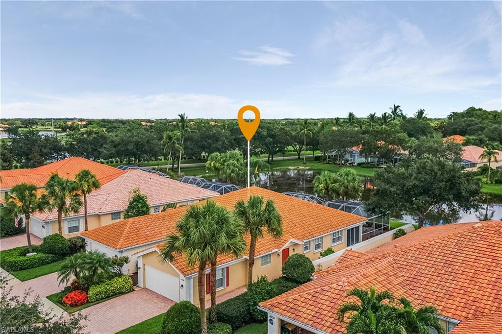 Don't miss this Villa in the coveted Island Walk gated community! Beautifully updated with quartz countertops, new roof, enclosed lanai, hard wood floors, plantation shutters, crown molding, fresh paint, built-ins & more! Beaming with natural light, this open concept 2 Bed + Den with 2 Car Garage and water views offers the perfect space to enjoy the finest Florida living. Located just 8 miles from the beach, you can relax with electric storm shutters for added protection and a maintenance free lawn. Enjoy everything you need within the gates - a town center, post office, car wash, gas station, two pools, tennis courts, miles of walking paths, fitness facility, restaurant, bocce ball courts, putting green, pickleball courts and more. Come call this active community home!
