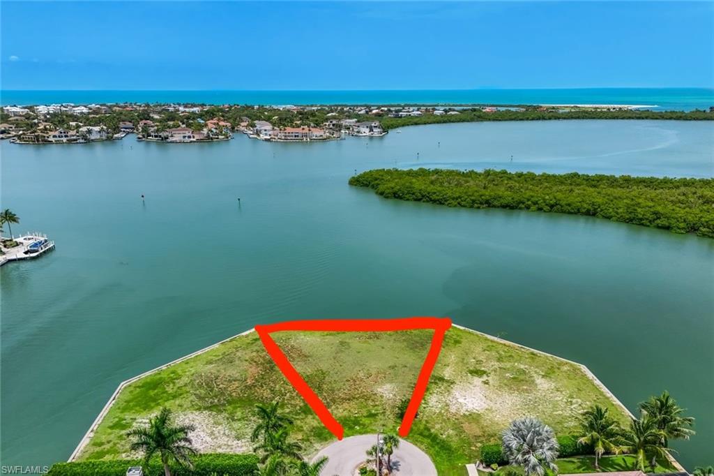 Build your dream waterfront home on this exceptional tip lot at the end of prestigious Rockport Court. Boasting 155 feet of seawall, replaced in 2014, this oversized property offers expansive western exposure with spectacular year-round sunsets. Enjoy direct Gulf access with no bridges, making it ideal for boaters seeking quick and effortless access to open water. Situated in one of the area's most desirable locations, this rare homesite combines panoramic water views, and an unbeatable boating lifestyle. Just minutes from premier waterfront dining, shopping, and entertainment, this is a unique opportunity to own one of the finest waterfront parcels available.
