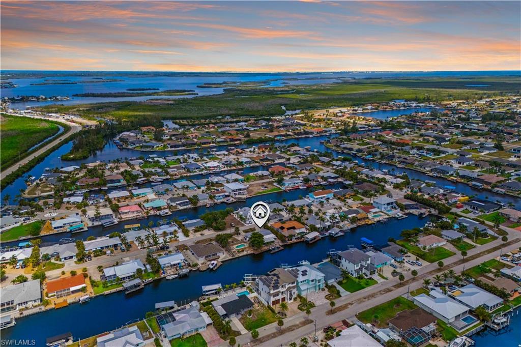 SAILBOAT ACCESS -125' of SWFL WATERFRONT LIVING WITH A POOL
Direct Gulf Access to enjoy Southwest Florida’s world-class fishing and island hopping!
This expansive property offers unmatched space and potential in one of Florida’s most colorful and charming coastal communities. Perfectly tucked away in unincorporated Matlacha Isles, this property offers owners fewer municipal restrictions, has city water and sewer in place, and no assessments. A huge 63-foot private dock extends into the water and includes a 12,000 lb. capacity boat lift. 
A paradise for boaters and fishing enthusiasts, this property sits on a deep, wide canal with no bridges, offering quick boating access to Matlacha Pass, Cayo Costa, Boca Grande, and many other beautiful surrounding islands. Whether by car or boat you will find yourself minutes from the colorful Matlacha arts district offering waterfront dining, local art galleries and boutique shops that provide the perfect blend of relaxation and entertainment.  
The home itself has a spacious layout and has good bones but would benefit from some updating. Still, it’s the lot that truly sets this property apart—double the size of most in Matlacha, incredible views, and endless waterfront possibilities. Don’t miss your chance to own this property, value is heavily reflected in the oversized waterfront lot and is an outstanding opportunity for investors and builders. Conveniently close to all that Cape Coral offers and approximately 30 minutes to Downtown Ft. Myers, Downtown Punta Gorda and Punta Gorda Airport. 
Great vacation destination!