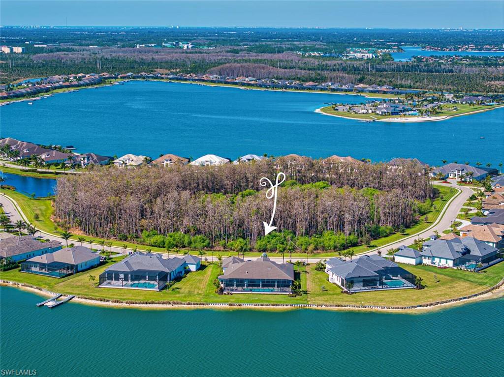 This magnificent Stock Custom Home located on the exclusive peninsula in WildBlue offers exceptional waterfront living in the expansive Winfield floorplan. Exquisitely furnished by award-winning SOCO interiors the residence offers curated luxury and livability. The design provides the ultimate in indoor-outdoor living with every room on the back of the home opening via sliding doors to the more than 4000 square feet of spectacular outdoor living. The spacious residence features 4,876 air-conditioned square feet with great room, 4BD+bonus room and home office, 5 full and 2 half baths, 300+ bottle temperature-controlled wine room & epoxied 4+car garage with large motor court and circular driveway. 
Beautifully designed with custom furnishings and high-end finishes, this home is being offered fully furnished and accessorized. The subtle, timeless interiors include designer lighting, thoughtful architectural ceiling details unique in each room, a morning coffee bar and additional full wet bar with refrigeration drawers, 10” baseboards, crown molding, custom doors, wide-plank wood flooring, large-format tile with wood inlays, and full house smart home Control4 automation for ultimate convenience.
The chef’s kitchen offers Wolf/Subzero appliances, a 12-foot center island, custom cabinetry with pull-out drawers, and large walk-in pantry. A lake-view dining area with seating for ten opens to the outdoor dining space for wonderful connectivity for even the largest dinner party! 
The primary bedroom is adjacent to the dedicated home office and offers views of the lake via French doors. This private sanctuary offers spacious dual his and her walk-in closets, a spa-like bathroom with double vanities, freestanding soaking tub, large walk-in shower with multiple shower heads, and his and her water closets. Three additional spacious en suite bedrooms each accommodate a king bed. The light-filled bonus room is adjacent to the morning coffee bar overlooking the lake with sliding doors to the outdoor living for the most serene way to begin your day.
The incredible outdoor living complemented by stunning lake views nearly doubles the living space and is designed for entertaining and large family enjoyment. Guests can relax in the outdoor living room with gas fireplace, chat at the bar while the host grills in the summer kitchen equipped with sink, refrigerator, and ice maker, dine al fresco, or enjoy a moonlit conversation around the natural gas fire pit.  Each space is delineated by unique architectural ceiling details. The saltwater pool includes a spa, swim-up bar, and sun shelf to enhance your Florida lifestyle enjoyment.  A boater's paradise, the property allows for a backyard dock. Welcome to your Florida Oasis!