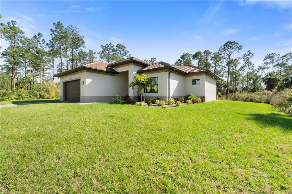 WOW! This modern luxury 3 Bedroom 2 Bathroom home in Naples, FL was completed in 2022 on a 2.27 Acre 100% Uplands lot on a quiet street in Golden Gate Estates. With an open floor plan, 10-foot-high ceilings, marble floors, 8-foot-tall doors, and high baseboards throughout the entire home, no detail was spared. The gourmet kitchen is complete with Granite Counters, Stainless Steel Appliances including double oven, oversized island and white shaker, soft-close cabinets. Also equipped with an automated sprinkler system on the grass and landscaped areas and plenty of natural wooded areas offer endless possibilities. The list of upgrades also includes Impact Resistant Windows & Doors, Custom Built in Walk-In Closet, a 500-gallon whole-home Reverse Osmosis water filtration system, built in Bluetooth Ceiling Speakers, High-End Indoor / Outdoor Surveillance Camera System, Custom Lighted Mirrors and floating bathroom vanities in both bathrooms, and epoxy floors in the 2-Car garage.  The oversized screened lanai and in-ground HEATED POOL create your own private paradise! Conveniently located close to Golden Gate Blvd. and 1.5 MILES from the brand-new Everglades Square Shopping Center!