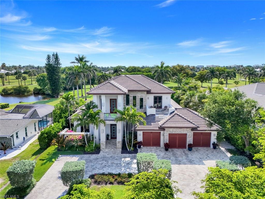Welcome to your slice of paradise nestled on the prestigious Moorings Golf Course, where luxury living meets unparalleled natural beauty. This exquisite single-family home, perfectly positioned on the 15th green, offers an idyllic retreat for families and entertainers alike. Boasting 4 spacious bedrooms, a den, and 4 full bathrooms and 2 half elegant bathrooms, this residence is designed for comfort, style, and modern living. From the moment you step through the grand entrance, you will be captivated by the home's soaring vaulted and tray ceilings, elegantly adorned with crown molding that adds a touch of sophistication to every room. The expansive living area features gas fireplaces both indoors and on the outdoor patio, creating a cozy ambiance for family gatherings and intimate evenings under the stars. The heart of the home is the gourmet kitchen, a chef's dream, outfitted with top-of-the-line appliances including a Wolf double oven, Bosch dishwasher, and a Sub-Zero built-in refrigerator/freezer. Whether you're hosting a dinner party or preparing a weekday meal, the dual facets and mini bar refrigerator with ice maker make entertaining effortless. Adjacent to the kitchen is a spacious dining area that flows seamlessly into the living space, with recessed impact glass quad sliders that invite natural light and provide breathtaking views of the lush golf course and tranquil lake.  Retreat to your opulent master suite, a true sanctuary featuring blackout shades, his and hers walk-in closets, and a spa-like en-suite bathroom.  Each additional bedroom is generously sized, offering privacy and comfort for family members or guests.  Additional office area and another living room on 2nd floor. Step outside to your personal oasis: a beautifully landscaped backyard with a sparkling pool and spa, perfect for sun-soaked afternoons and sunset soirees. The outdoor fireplace and firepits provide the ideal setting for cozy gatherings, while the expansive second-story balcony treats you to sweeping views of the golf course and stunning sunsets, making every evening a picturesque experience. This property is equipped with modern conveniences including a dedicated laundry area on the first floor and washer / dryer hook up on the second floor, two tankless hot water heaters installed in 2022, new HVAC system in 2021, and new pool heat pump installed in 2025. The additional storage room ensures you have plenty of space for all your essentials. Safety and comfort are paramount, with recessed electric screens and shutters protecting your investment. As part of the Moorings community, you'll enjoy exclusive access to a private beach club, which has parking, restrooms, and offers the ultimate coastal lifestyle. Whether you're hitting the links, lounging by the beach, or enjoying the vibrant local dining and shopping scene, this location truly has it all. No HOA Fees - No rental restrictions - No pet restrictions - Investor friendly - Not in a Flood Zone