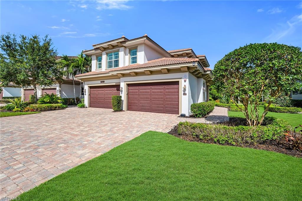 Discover the ultimate blend of luxury, privacy and convenience in this furnished Stock Construction residence, ideally positioned behind the guarded gates of Tasori within The Classics at Lely Resort. Offering the spacious feel of a single-family home combined with low-maintenance ease, this exceptional home welcomes you through a private foyer where your private elevator, installed in 2021. Thoughtfully designed, this desirable floor plan features three spacious bedrooms, three full baths and an expansive club room ideal as a media room, home office, library or additional gathering space. The chef-inspired kitchen is designed for both everyday living and entertaining, showcasing upgraded cabinetry with designer island panels, premium stainless steel appliances and a professional hood vented to the exterior. Elegant marble countertops and a matching marble backsplash create a sophisticated focal point while seamlessly connecting to the open-concept living and dining areas. Select appliances have been updated in recent years, further enhancing the home's appeal and functionality. Plantation shutters, designer lighting and modern fixtures complement the refined interior finishes throughout. The screened lanai, where peaceful tree-canopy views and glimpses of the community water feature create a tranquil backdrop for relaxing or entertaining. Impact-resistant windows and doors provide added peace of mind, while motorized hurricane screens on the lanai offer additional storm protection and function as convenient sunshades for year-round comfort. The primary suite serves as a private retreat with direct lanai access, a comfortable sitting area and a spa-inspired bath featuring a freestanding soaking tub, large walk-in shower and a custom-designed walk-in closet with built-in organizers. New upgraded shower heads have been installed in both the primary bath and the en-suite guest bath, while a Comfort Home instant hot water system adds everyday convenience and efficiency. Two guest suites offer exceptional privacy and comfort. Both guest bedrooms include spacious walk-in closets, creating an inviting experience for family and visitors alike. Additional highlights include a generously sized laundry room with a utility sink and extra cabinetry, an epoxy-finished two-car garage, conveniently located guest parking directly across from the driveway, a private elevator and electric hurricane screens. Tasori residents enjoy access to a private neighborhood pool, clubhouse and grilling area, along with a deeded membership to the renowned Players Club & Spa. This resort-inspired amenity center features multiple pools with waterfalls, a tiki bar and restaurant, fitness center, full-service spa, tennis courts, pickleball courts and vibrant social activities and events. Three championship golf courses are located within Lely Resort, creating an exceptional lifestyle opportunity in one of Naples' most desirable communities.