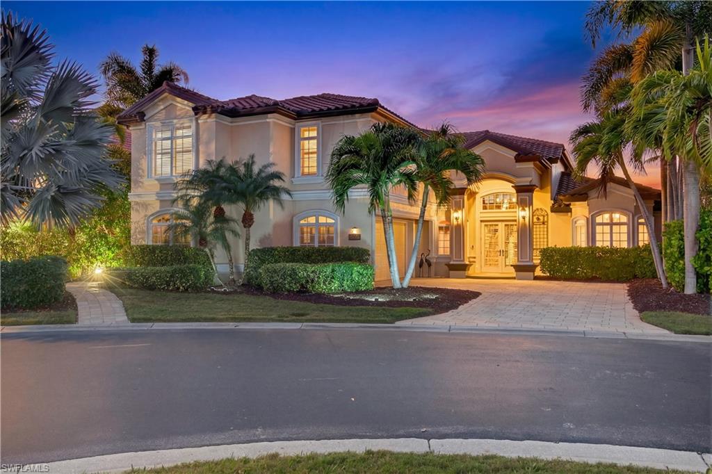 Set along the Caloosahatchee River in Riverside Estates, this extraordinary residence was engineered as a true coastal fortress — and positioned in the highly desirable X500 flood zone for added peace of mind. A double concrete seawall secures the shoreline. Solid concrete core pillars and crossties reinforce the screened enclosure. Impact-rated windows and doors, a NEW ROOF (2022), and electric roll-down storm screens provide layered protection—all seamlessly concealed behind refined architectural detailing so that beauty, not structure, commands attention. Here, the focal point is what matters most: panoramic water views and painted-sky sunsets that feel like a nightly private showing by nature. A 160-foot private pier extends gracefully into the river, capable of accommodating vessels with 10-foot beams and up to 36 feet in length—offering exceptional flexibility for boating enthusiasts. For those with larger vessels, the owners’ 50-foot wet slip at the Riverside Marina is also available. Just beyond the screened lanai, a 20x8 open-air waterfront deck creates the perfect setting for sunbathing, and front-row seating to Fourth of July fireworks and seasonal boat parades. Outdoor living is designed for every season. A heated pool and spa invite year-round enjoyment. The covered outdoor kitchen sets the stage for effortless entertaining. A sprawling sunroom with a heat-producing fireplace creates warmth and ambiance on cooler evenings, blending comfort with the ever-present backdrop of the river through 9-foot sliding glass doors. Inside, soaring 20-foot ceilings and LED-backlit coffered details elevate the living spaces with quiet drama. The expansive primary suite is thoughtfully positioned on the first floor, offering both privacy and convenience. Upstairs, three guest suites—each with en suite baths and dual-sink vanities—deliver comfort and independence. An upstairs morning kitchen and laundry area create a retreat-like experience for guests. The open loft and study area opens through French doors to an oversized balcony—perfect for morning coffee, virtual meetings with a view, or unwinding as the sun sets over the water. On the main level, a dedicated office with a walk-in closet and Murphy bed offers flexibility as a fifth bedroom without compromising sophistication. Both offices are appointed with adjoining private baths. Located in Riverside Estates and accessed through The Landings gated main entrance, residents enjoy the rare balance of privacy and optional full or social membership to The Landings with executive golf course, tennis, two restaurants and a full calendar of events—while maintaining their own riverfront marina lifestyle within Riverside Estates. Ask your agent for The Full Scoop—insight beyond the MLS, including detailed features, upgrades, and ownership highlights designed to provide clarity and confidence.