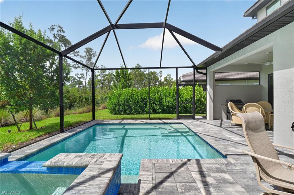 This exceptional Abaco Pointe villa embodies a warm contemporary aesthetic, where soaring ceilings, sculptural statement lighting, organic textures, and light-filled interiors create an atmosphere of understated luxury. At the heart of the home, the chef-inspired kitchen showcases quartz countertops, abundant custom cabinetry, natural gas cooking, a generous center island, and an expansive walk-in pantry. The open-concept living and dining areas transition seamlessly to the screened outdoor retreat, where a sparkling pool and spa overlook lush tropical landscaping, creating a private setting for year-round relaxation and entertaining. Designed with comfort and privacy in mind, the thoughtfully crafted split-bedroom floor plan offers three spacious bedroom suites, each with its own beautifully appointed bath. The primary suite boasts a custom-designed walk-in closet and spa-inspired bath, while the guest suites continue the home's elevated aesthetic with equally refined finishes. Upstairs, an expansive loft offers exceptional flexibility as a media room, home office, fitness studio, playroom, or additional lounge space. Perfectly positioned in the gated community of Abaco Pointe, residents enjoy a peaceful setting just minutes from Naples' world-class beaches, Fifth Avenue South, Mercato, Waterside Shops, championship golf, and exceptional dining and entertainment.