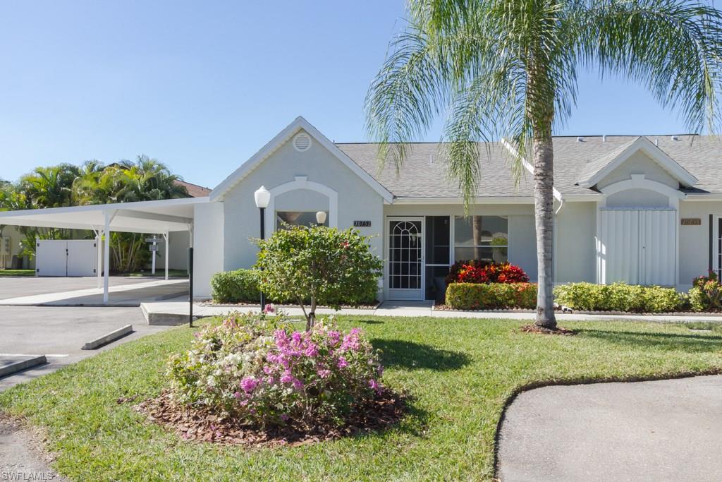 Terrific End Unit, Villa in wonderful N. Naples neighbourhood. This home offers a great screened entryway, vaulted ceilings, lush landscaped view and steps to the community pool.  The villa has 2 bedrooms, 2 baths, an eat-in kitchen area, and spacious Living Room with room for a Dining area also.  Step out onto the lanai and enjoy the cool breezes, Western exposure and relaxing atmosphere of Florida living.  There is a carport and extra storage room with the home and you are located close to local shops, the beaches, restaurants and only about 20 minutes to RSW airport.