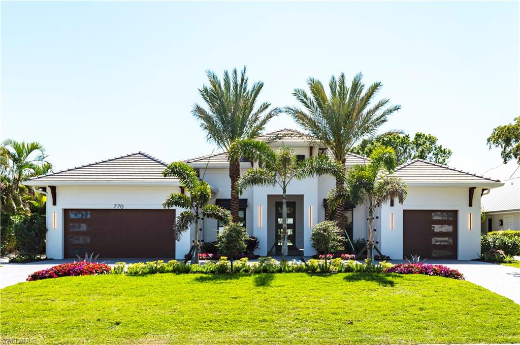 STRATEGICALLY LOCATED NEW CONSTRUCTION 4/5 BDRM POOL HOME makes for a solid investment! Immerse yourself in one of the most coveted Naples neighborhoods "The Moorings," with upscale beaches, world-class dining, and private clubs just moments from your door. Positioned on a quiet, low-traffic street in the X-Zone (low flood risk). Perfectly crafted by builder "Robert D'Angelo Jr Custom Homes,"  finishes by "Oak and Fifth Design," and beautiful decor/furnishings by "Clive Daniels." The grand entrance offers a 4-panel glass Mahogany-finished impact entry door, meticulously designed Cypress Corbels and Boral Saxony Slate Tile Roof.  Professionally landscaped with twin Medjool palms and dramatic 3D effect art lighting. Inside, 8” European White Oak hardwood flooring flows throughout, accented by 9 ½” baseboards and custom inlays. The open-concept living and dining area showcases a custom oak feature wall and art lighting, perfect for both intimate gatherings and grand entertaining.
A beautiful custom kitchen with white contemporary cabinetry, 12’ island with River Blue Extra Quartzite countertops, and professional-grade SubZero/Wolf/Cove appliances, including an LP gas range top. A walk-in pantry with shelving and quartz countertops completes this culinary haven.
The Master Suite offers a spa-like retreat, boasting a wet room, a freestanding soaking tub, rain shower, marble herringbone mosaic tile flooring, two separate restrooms, and custom dual vanities with Calacatta Dolomite Quartzite countertops. Two expansive custom closets feature built-in mirrors, quartzite countertops, and locking jewelry drawers.  
FEATURES:
* Oversized Master Suite and Three Additional Bedrooms, en-suite bathrooms and custom closet systems.
* Two Additional Bonus Rooms offer many options.  The "Den" is perfect space for cards, cocktails & conversation, and offers built-in cabinetry with two Sub Zero refrigerator drawers; and The "Office." All rooms offer sound proof insulation.  
* The Outdoor Oasis has an outdoor kitchen with a built-in LP gas grill, SubZero outdoor refrigerator, 60” linear fireplace, and motorized hurricane shutters & screens.  
* Resort-Style Pool & Spa has fire/fountain bowls and marble lanai pavers.
* The Laundry Room has custom cabinetry, GE Steam Washer & Dryer, and a True undercounter ice maker and custom drying racks.  
MECHANICALS:
This home is equipped with a 20kW generator, 500-gallon underground LP gas tank, two high-efficiency AC split systems, tankless water heaters, Icynene spray foam insulation, a security system, and a whole-house audio and network system.  Three car garage spaces, both have drop down ladder attic access and epoxy floors.      
LOCATION-LOCATION-LOCATION: 1.5 Miles to "The Moorings Beach,"  2.5 Miles to the newly constructed "Four Seasons Beach & Golf Club,"  3 Miles to Downtown Naples 5th Ave Dining/Shopping.   This proximity adds to a sound valuable investment with wealth and growth all around.