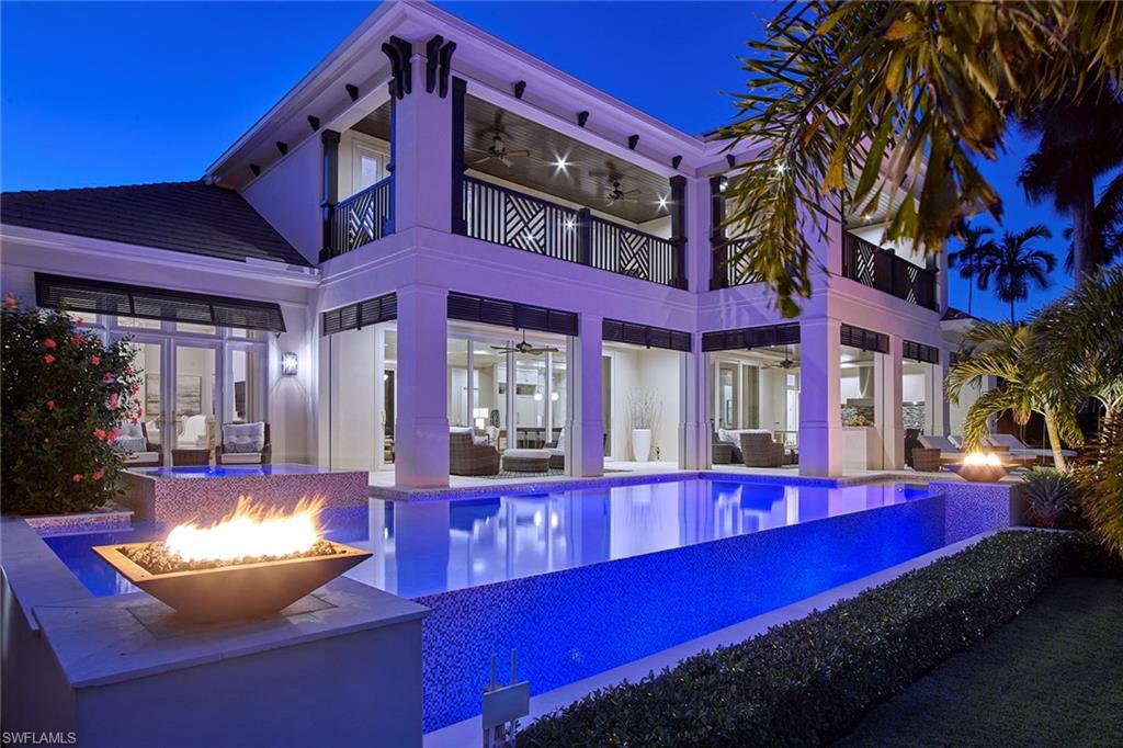 Perfectly situated on one of Aqualane Shores' premier streets, this remarkable home provides all the comfort of new construction with all the amenities and convenience of aftermarket upgrades. Owners will appreciate the expansive synthetic dock with 40,000 lb lift and separate submergible, no profile lift. The expansive covered and uncovered outdoor area perfectly complement the dock area with gourmet summer kitchen, fireplace, fire bowls and electric roll down screens and shutters. The modern interior leaves no luxury to be desired and features Sub-Zero and Wolf appliances, custom marble fireplace, wide plank white oak floors, glass in wine room and a neutral color palette throughout. Quick access to the Gulf and close proximity to fine shopping and dining on 5th Ave and 3rd St S make this the ideal location to enjoy all Naples has to offer.
