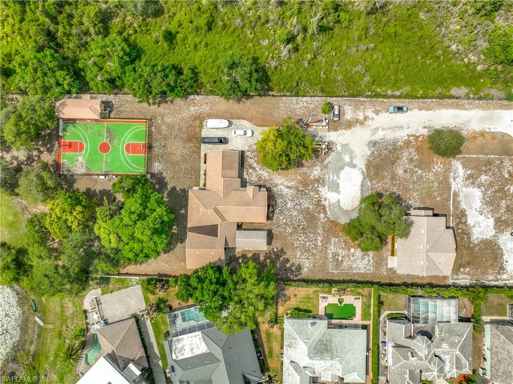 OVER 5 ACRES, RIGHT IN THE HEART OF ORLANDO, WITH MULTIPLE STRUCTURES, A BASKETBALL COURT, AND EXPANSIVE LAKE FRONTAGE — NO HOA!

This one-of-a-kind property includes two parcels totaling more than 5 acres and is being sold together. The seller will not separate the parcels.

The main residence features a spacious 3-bedroom + den, 3-bathroom floor plan with a large kitchen and an open great room designed for entertaining. The third bedroom, full bathroom, and den/living area have a private entrance, making it ideal for multigenerational living, guest accommodations, or potential rental income.

Outdoor amenities include a full basketball court with restrooms and a covered grilling area, creating the perfect setup for recreation, events, or gatherings. The expansive lakefront setting offers opportunities for canoeing, kayaking, and fishing, all while enjoying peaceful waterfront views.

The second parcel includes an additional versatile structure that was most recently used as a workout facility. Complete with a full kitchen, office space, full bathroom, and one-car garage, this building offers endless possibilities for personal, recreational, or business use.

Rarely does a property of this size and versatility become available in the middle of Orlando. Whether you are looking for a private family compound, income-producing opportunity, event space, or recreational retreat, this unique waterfront property offers unmatched potential with no HOA restrictions.