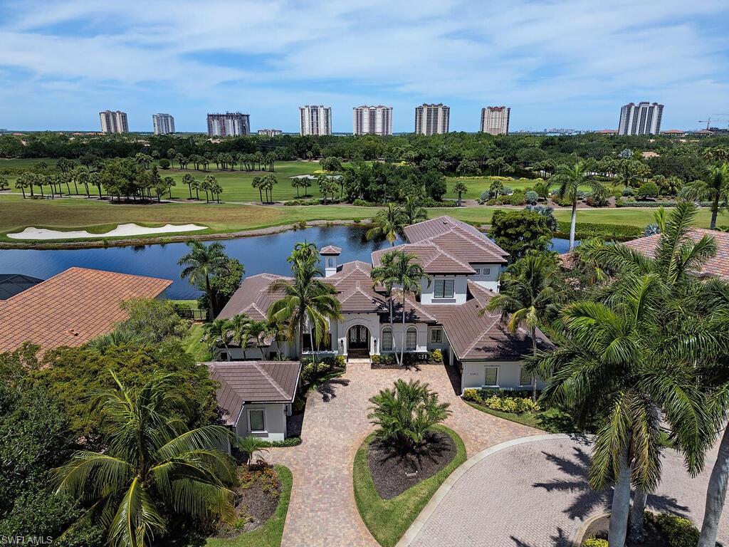 Exquisitely designed, two-story turnkey furnished estate home located within the exclusive enclave of Messina Court in The Colony Golf & Bay Club. Built in 2005 to the exacting standards of its original owners, this exceptional residence is perfectly positioned on one of the community’s most scenic golf and waterfront homesites.
Soaring ceilings reaching up to 20 feet and dramatic floor-to-ceiling windows frame breathtaking panoramic views across the infinity-edge pool and outdoor living area, spanning three fairways, the Country Club, and the signature 18th-hole fountain. With a coveted southwest exposure and no neighboring homes in sight, the setting offers a rare sense of openness and privacy unique to Southwest Florida.

The home is richly appointed with high-end finishes and thoughtful details throughout, including hurricane-impact windows and doors, marble and wood flooring, a grand marble staircase, a brand-new Lutron lighting system, and expansive zero-corner pocketing sliders that seamlessly blend indoor and outdoor living. The residence offers four spacious bedroom suites, 5.5 baths including a luxurious pool bath, electric hurricane shutters, motorized lanai screens, an outdoor linear fireplace, and a three-car garage plus a separate golf cart garage.

In 2023, the exterior was refreshed with a light, modern palette and complemented by a new flat tile roof with dark gutters, enhancing its contemporary curb appeal.

The oversized chef’s kitchen is designed for both functionality and entertaining, featuring Wolf and Sub-Zero appliances, a six-burner gas range, three ovens, and multiple prep areas. The primary suite serves as a private retreat, complete with custom closets, a sculptural floating soaking tub, and a fully glass-enclosed garden shower set within a walled courtyard for ultimate privacy.

The second level offers exceptional guest accommodations, with three ensuite bedrooms, a spacious gathering area featuring a beverage refrigerator and coffee bar, and access to a private balcony.

Residents of The Colony enjoy membership to the newly renovated, private waterfront Bay Club, offering two levels of dining along Estero Bay, as well as access to Pelican Landing’s exclusive 34-acre island beach park and pavilion. Golf membership at The Colony Country Club is optional.

Ideally situated in a high-and-dry location outside of a flood zone, this home combines luxury, privacy, and lifestyle in one of Southwest Florida’s most sought-after communities.