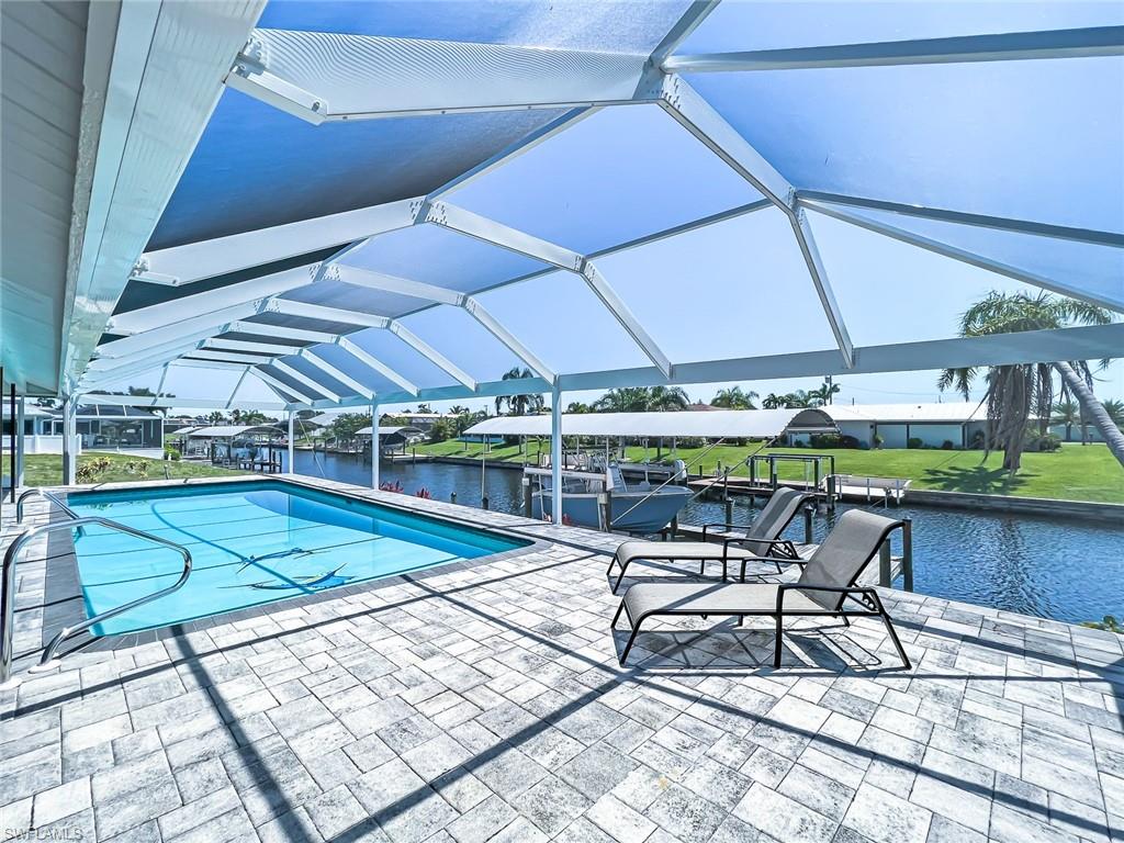 Motivated Seller Offering Buyer Incentives! Welcome Home to this Stunning Updated Gulf Access Pool Home. You will enjoy all of the Inside and Outside Living Areas with Intersecting Canal Views. The Wall of Sliders makes the home light & bright. An Open Concept Floor Plan really allows you to bring the Outside in. This home is Perfect for Entertaining & Families and just a Short Boat Ride out to the ICW/ Caloosahatchee River for the avid boater. A Custom Heated Salt Water Pool for year around enjoyment. The ample Sunning area is accessible from both primary and guest bedrooms. The Captains Walk Dock has a 12,000# Lift with Remote and Coverall for your Boat. The Interior and has been freshly painted, Hurricane impact windows, New Roof & Pool Cage & Hot Water Heater. The Chef in the Family will enjoy the updated Kitchen with Wood Cabinetry, Onxy Counters, Induction Cooktop & Wall Oven and ample storage. Porcelain tile floors throughout the home adds a touch of elegance and is easy to maintain. The location is unbeatable.  Established SE Cape Coral neighborhood, but yet close to everything.  You'll love coming home to this peaceful oasis, where you can unwind and recharge after a long day. Don't miss your chance to own this incredible home - schedule a showing today!
