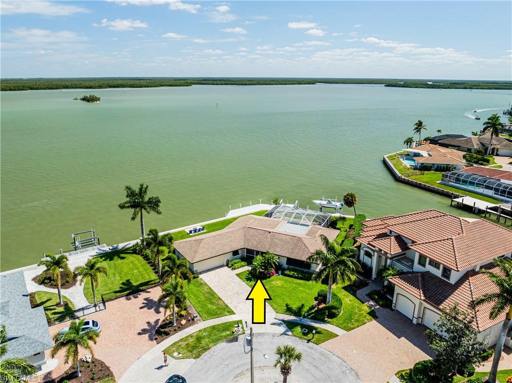 Fantastic key lot with unobstructed wide water views of the river and Bird Islands. 170 feet of new vinyl seawall and cap 2023, new dock 2023 and new deck and jetski lift 2024. New pool heater and saltwater pool system 2023. New hot water heater, refrigerator, dishwasher, washer/dryer 2023 and microwave 2024. Good rental history. Conveniently located with easy access on and off the Island in this most desirable river area and just minutes from the beach, shopping and dining