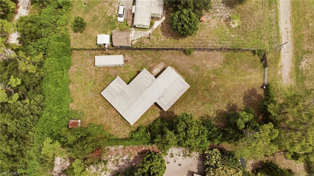 Opportunity awaits on this fully fenced HALF ACRE property at the end of a quiet dead-end street in North Fort Myers! Complete with a gated entrance, this property offers added privacy and plenty of potential. Being sold AS IS, the sale includes the existing mobile home, as well as a trailer filled with tools and equipment, all of which will remain with the property at closing. The condition of the mobile home is unknown, and no value is being assigned to the structure. Conveniently located just minutes from I-75, the Lee County Posse Arena, and the Lee Civic Center, this property offers easy access while still providing a peaceful setting. Whether you're looking for your next investment, a future homesite, or a project property, this is an opportunity to make it your own.