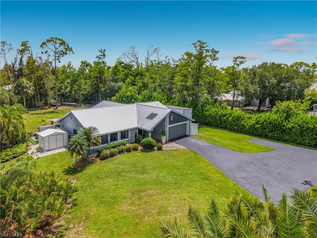 Nestled near the end of a cul-de-sac, this beautifully remodeled home offers the perfect blend of privacy and convenience. With 1.04 acre of AG-2 zoned land, no HOA, and no evidence of flood damage from prior hurricanes. This property provides exceptional flexibility with abundant room for boats, RVs, trailers, or play. Property Highlights Modern Upgrades: metal roof and gutters (2025), on-demand water heater (2026), and a (2020) AC system with extra insulation.Kitchen/Great Rm: Open concept vaulted ceiling, giant 6-seat granite island, soft-close cabinetry with large drawers, single basin sink, stainless appliances, RO system (2020), and a step-in pantry all flowing seamlessly into the living area.Luxury Primary Suite: Tastefully remodeled with dual sinks, a free-standing tub, walk-in closet and floor-to-ceiling tiled shower. The primary bath also serves as a convenient cabana bath leading to the outdoor living area.Outdoor Oasis: 12’ x 33’ covered lanai with outdoor shower, extending another 14’ for a 6-person Master spa, and an easy-to-care-for above-ground pool.Home: 3 bedrooms with fourth flex room (wood frame construction this room only) and extra-large dining rm Most windows are impact-rated, featuring a modern garage door, and exterior paint (2024). Upgraded underground electrical with a generator transfer switch, rainbird 12 zone smart irrigation (2021) This home has a private well (2025). And is on a septic system. The Grounds The paved circle driveway offers ample parking, while three storage sheds and a wrap-around porch complete the exterior. The lush, landscaped grounds are fenced on two sides, with a smaller fenced area by the pool, creating a private tropical sanctuary including a few fruit trees and pineapple plants. Location Enjoy this great location minutes away from local beaches, shopping, healthcare, the airport, and major thoroughfares. This unique property combines privacy, flexibility, and modern upgrades in a hard-to-find setting.