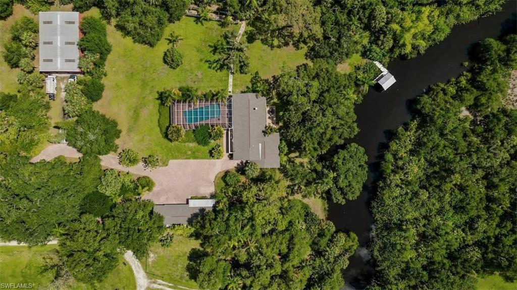 MOTIVATED REDUCTION *** $-100,000.00 *** PRICE IMPROVEMENT REFLECTS SELLER MOTIVATION. PRICED TO MOVE AT AN UNBEATABLE VALUE!

UNPRECEDENTED VALUE AND OPPORTUNITY. 3.2 AC, 2 HOMES, 2400 SF RED IRON BARN, LAP POOL AND HUGE LANAI, NAVIGABLE WATER 500 YARDS TO CALOOSAHATCHEE RIVER DOWN RIVER OF LOCKS. ZONED AG-2. NO HOA, NOT IN A SUBDIVISIONS. PRESERVED TELEGRAPH VIEWS BY CONSERVATION EASEMENT. 

HAVE INSTANT EQUITY AND BE FREE IN YOUR FUTURE FROM ASSOCIATIONS AND RESIDENTIAL ZONING. 

This is a truly remarkable property that photographs can't do it justice. Such a beautiful oasis!! Private, peaceful,…Perfect for an Artist, writer, photographer or just a nature lover! The good life awaits!! Multigenerational property 2 home estate. Enjoy the workshop/barn of the 2400sf red iron/steel barn. Enjoy the screened recreational area with 40ft pool. Located on 344 feet of the navigable Telegraph Creek, 550 yards to the Caloosahatchee river. Feel the privacy in this 3.2 acre estate. ZONED AG 2! Mature oaks & pines, find yourself in the secret, equestrian and recreational Hideaway of Alva, Florida! The tranquility and elegance of this 3.2 acres rich in classic southern style charm. 
DETAILS: Main house is 2422sf 3/2 with grand open spaces. The kitchen features state of the art amenities, including BLANCHE quartz countertops, stainless steel sink, eye-catching subzero, classic French door, refrigerator freezer. Chef‘s choice of the induction range, convection, double oven and an easy to reach conveniently located microwave oven. Designer cabinetry, with soft, closing drawers and heavy hinge, including a large walk-in pantry with designer doors, and stainless steel barn door hardware.  The multi Chef kitchen will support the families best chefs at holidays and gatherings with the island kitchen as the social hub of the 700 ft.² gathering space. A large family room is the hub for the three bedrooms on the north side of the house. The family room features a wood-burning fireplace, and panoramic veiws of the backyard and the telegraph creek. The master suite includes a large walk-in closet and private bath with dual sinks and a spacious custom shower. Private access into the lanai and pool area. The second bedroom, with a vaulted ceiling and access into the pool lanai area. The third bedroom features, built-in open bookshelves, + large size walk-in closet. 
BONUS!! 1090 ft.² guest house with carport. Full functioning, with living room, dining room, and a fully equipped kitchen in the central space, full laundry, hook ups, independent HVAC from main house, and a bedroom located on each end of the living space. A large screened, private lanai invites you to relax and enjoy.
A 40 x 60 red iron steel building with three overhead doors and an access door, on a monolithic pour of concrete is here for your needs.