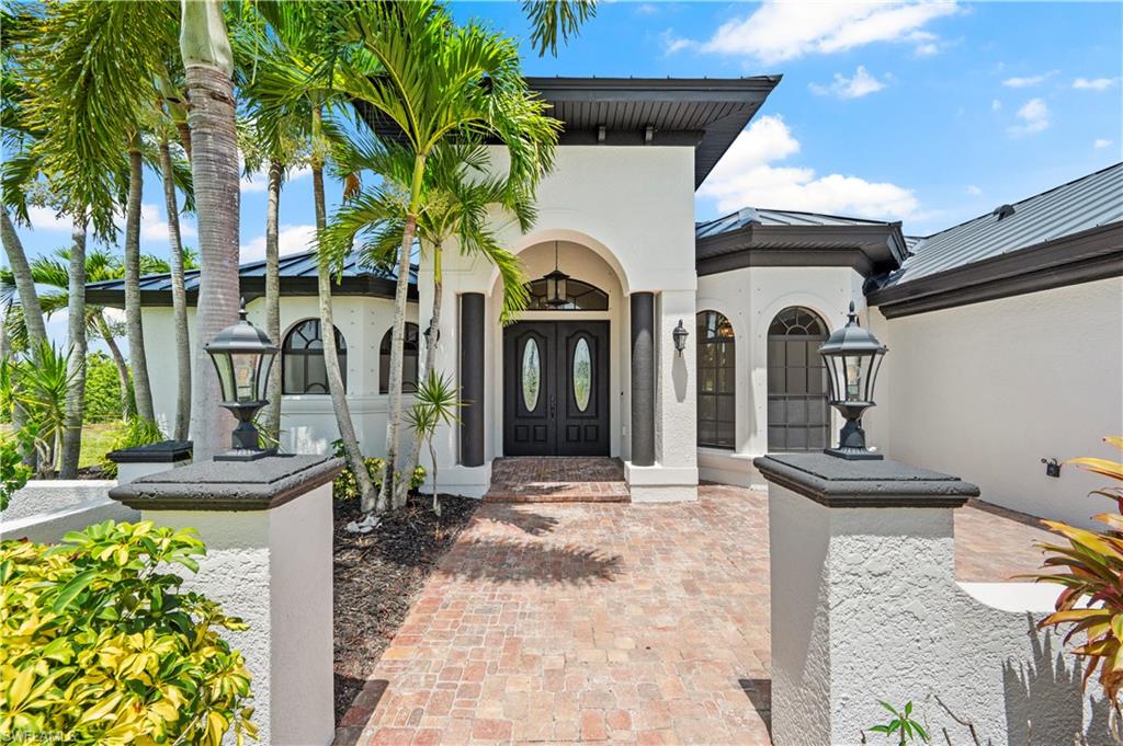Welcome to your own slice of waterfront paradise! Gulf-access pool home offers the perfect blend of luxury, comfort and the Florida lifestyle you've been dreaming of. Ideally situated just off Embers & Burnt Store Rd, you'll enjoy a quick 15 min boat ride to open water from your private dock, complete with a covered boat canopy and new lift motor. Designed for both everyday living and entertaining, the expansive screened lanai features a sparkling pool with an infinity edge waterfall, an integrated spa and plenty of space to relax or entertain while enjoying breathtaking western sunset views. Inside, this spacious 4 bedroom 3 bath home showcases elegant travertine flooring throughout, coffered and vaulted ceilings, inviting fireplaces in both the main living area and the primary suite. The luxurious primary bathroom is a true retreat featuring a soaking tub, waterfall walk-in shower and beautifully appointed travertine finishes. The well equipped laundry room includes a convenient utility sink and newer appliances. Enjoy peace of mind with numerous upgrades, including a new roof (2024), whole house water treatment system (2025), pool heater (2025), boat lift motor (2025), appliances (2024), inside & outside paint (2024). Whether you're an avid boater, love entertaining or simply want to enjoy spectacular waterfront sunsets from your backyard, this exceptional gulf access home offers the very best of southwest florida living at an exceptional price.