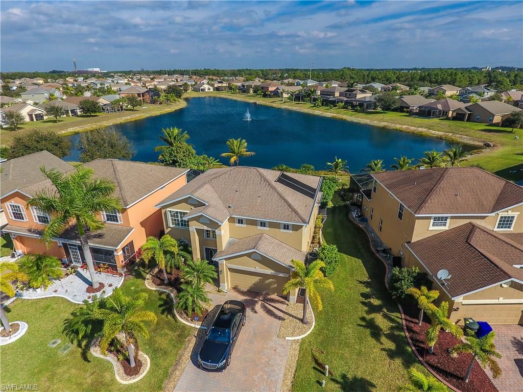 This property is immaculate! UNBEATABLE lake views from your extended paver patio with outdoor kitchen and solar heated pool! Newly renovated exterior by developer mint condition all around. Freshly landscaped. This large nearly 2300sqft 2 story 4 bedroom 2.5 bath home with 2 car garage features some unique upgrades such as outdoor kitchen with granite counters, surround sound in main living area, accordion and electrical shutters on second story, separate family room and living room, real Brazilian hardwood floors in family and dining rooms, as well as pavered driveway, and more!!! This is one you won't want to miss.  Extra cabinets/storage installed in garage, long 4 car driveway, massive extended lanai with extensive covered area!!