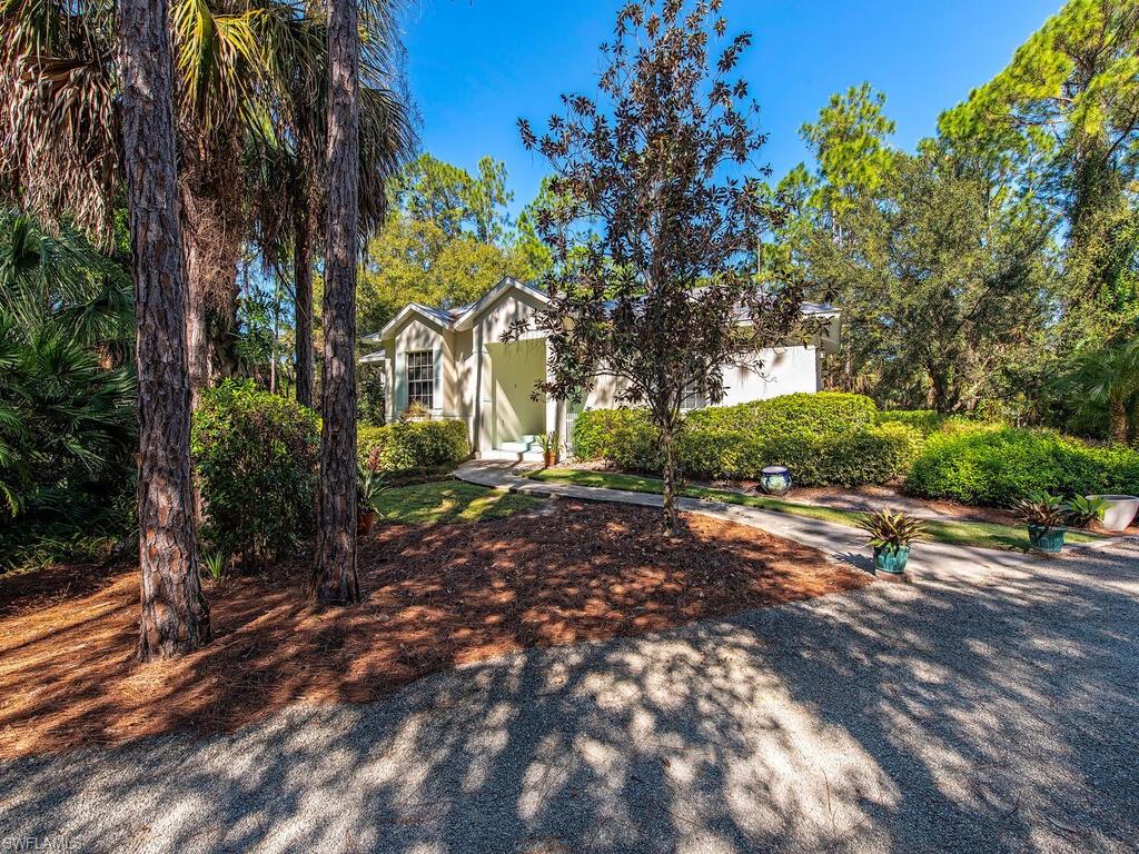 Move-in ready Key West style Cottage in Golden Gate Estates. This stunning home sits on 2.5 acres with a 2-stall horse barn and paddock.  The property features a great room concept with 2 bedrooms and 2 bathrooms sitting on a beautifully maintained and completely fenced in yard.  Enjoy the outdoors as well as plenty of storage for all your toys.  Once inside, you will enjoy the open kitchen & dining area with views of the open air porch and backyard.  The great room has vaulted ceilings and a wood-burning fireplace with french doors which lead to a wrap-around patio to enjoy everything this home and property has to offer. Fantastic location with easy access to Golden Gate Blvd.
