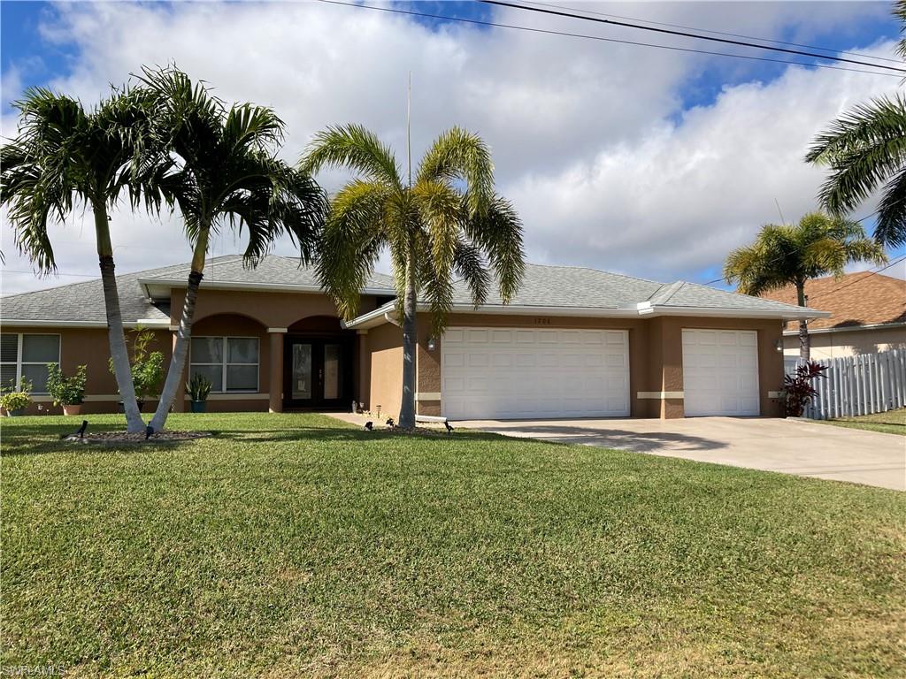 Come see this beautifully maintained Cape Coral pool home with a large open floor plan, huge paver lanai and pool area; private backyard with beautiful landscaping with palm trees and a banana tree.  This home has room for the entire family with 2415 square feet featuring 4 bedrooms large enough for king beds each has a walk-in closet. There is also a den/office area and 2.5 baths along with 3 car garage. The master bedroom has a sliding door to the pool. Very large bathroom with walk in shower, soaking tub, dual vanities w/granite counters. The master closet is very spacious. Guest bathroom offers access to the pool. Relax in the living room with high cathedral ceilings while having expansive views of the pool & lanai with two sliding doors that fully retract. The kitchen boasts of wonderful views of the pool/lanai.  It has beautiful white cabinetry, solid surface counters with a bar sitting area. Flooring is tile throughout, no carpet. There is 37 feet under cover on the lanai which has a western exposure to watch the sunsets.  Solar panels ensure that you can swim year around in privacy. This is a must-see home giving the buyer all the Florida lifestyle one desires