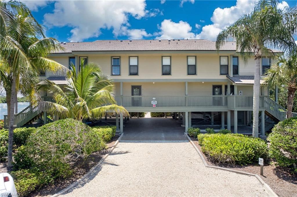 Experience SPECTACULAR WATER VIEWS from this beautifully positioned corner residence in the highly desirable Bocilla Island Club. This is widely considered the premier building in the community, offering panoramic water vistas from both levels and an abundance of natural light through additional side windows unique to this END UNIT.

For boaters and anglers, this property is truly a rare find. Included is a PRIVATE BOAT SLIP with a 10,000-pound lift, accommodating boats up to 24 feet, providing quick access to Charlotte Harbor, Boca Grande Pass, Cayo Costa, North Captiva, world-class tarpon fishing, backwater flats, and some of Southwest Florida’s most pristine beaches. Ask almost any local fishing charter captain and they’ll tell you these are among the finest fishing grounds in all of Lee County. Anglers can achieve the coveted Grand Slam of fishing right in the vicinity. Abundant Snook, Redfish, Sea trout, and Tarpon are just a few of many prized local catches

Relax on your screened lanai while watching dolphins, manatees, and boats cruise by, all with peaceful waterfront views as your backdrop. IMPACT WINDOWS AND DOORS provide peace of mind, while the floor plan offers a first-floor living area with a convenient half bath. Upstairs features a generous primary suite with breathtaking views, a walk-in closet, updated bath, private waterfront lanai, plus a guest bedroom with its own private bath. Additionally there is a convenient full sized laundry room.

Additional highlights include a private storage room adjacent to the covered parking space. The oversized assigned under building parking space has plenty of room for both your vehicle and golf cart. Seasonal rentals are permitted, making this an outstanding investment opportunity with an established rental history.

Bocilla Island Club offers a true resort lifestyle with two heated pools, tennis and pickleball courts, shuffleboard, beautifully landscaped grounds, scenic waterfront walking paths, a private fishing pier on Charlotte Harbor, and a kayak launch. Walk to nearby restaurants and Four Winds Marina, a full-service marina just minutes away. Flood insurance is included through the HOA.

Whether you’re searching for the ultimate winter escape, year-round waterfront residence, or income-producing vacation property, this exceptional home combines breathtaking water views, unmatched fishing and boating, and the laid-back island lifestyle that makes Bokeelia so special.