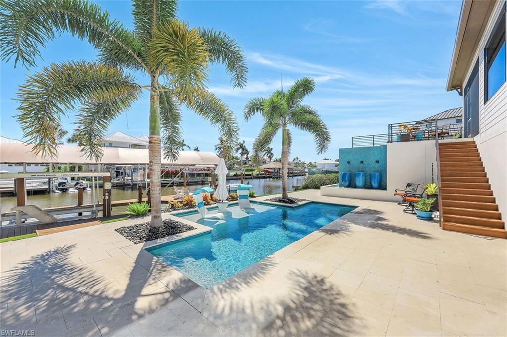 Welcome to your dream waterfront coastal contemporary oasis, newly rebuilt in 2021, nestled in the heart of North Naples. This exquisite three-bedroom, two-and-a-half-bath home offers an awe-inspiring view of Vanderbilt Bay, perfect for those who revel in the enchantment of nightly sunsets reflecting off the water.
As you step through the front door, you are greeted by a stunning, sweeping staircase that sets the tone for the rest of this meticulously designed residence.
The home boasts high-end craftsman custom trim work that weaves a thread of sophisticated charm throughout each space. The open and airy floor plan is a masterpiece in design, promoting a seamless flow that is as perfect for grand entertaining as it is for intimate family gatherings.
Culinary enthusiasts will delight in the gourmet kitchen, equipped with top-tier appliances, twin oversized islands, a steam oven, and gas cooking facilities. Storage is a chef's dream with spacious pantries that stretch from floor to ceiling.
Ensuring both style and security, the home features hurricane-
resistant windows and a robust metal roof. Quality of build is evident in every corner, echoing a standard of luxury that is second to none.
Outside, your personal oasis awaits with lush landscaping, a custom private spa retreat that seamlessly spills over to the lower water feature next to the lavish pool, outdoor shower & oversized pergola. 
Boating enthusiasts will appreciate the elite covered dock complete with two lifts and southern exposure with easy access to the Gulf of Mexico. 
Situated by Vanderbilt Beach, Delanor Wiggins State Park, Mercato, Whole Foods and Trader Joe’s as well as the finest shopping, dining, and entertainment options in the area.
This property does not just offer a house, but a lifestyle - making every day feel like a luxury vacation.