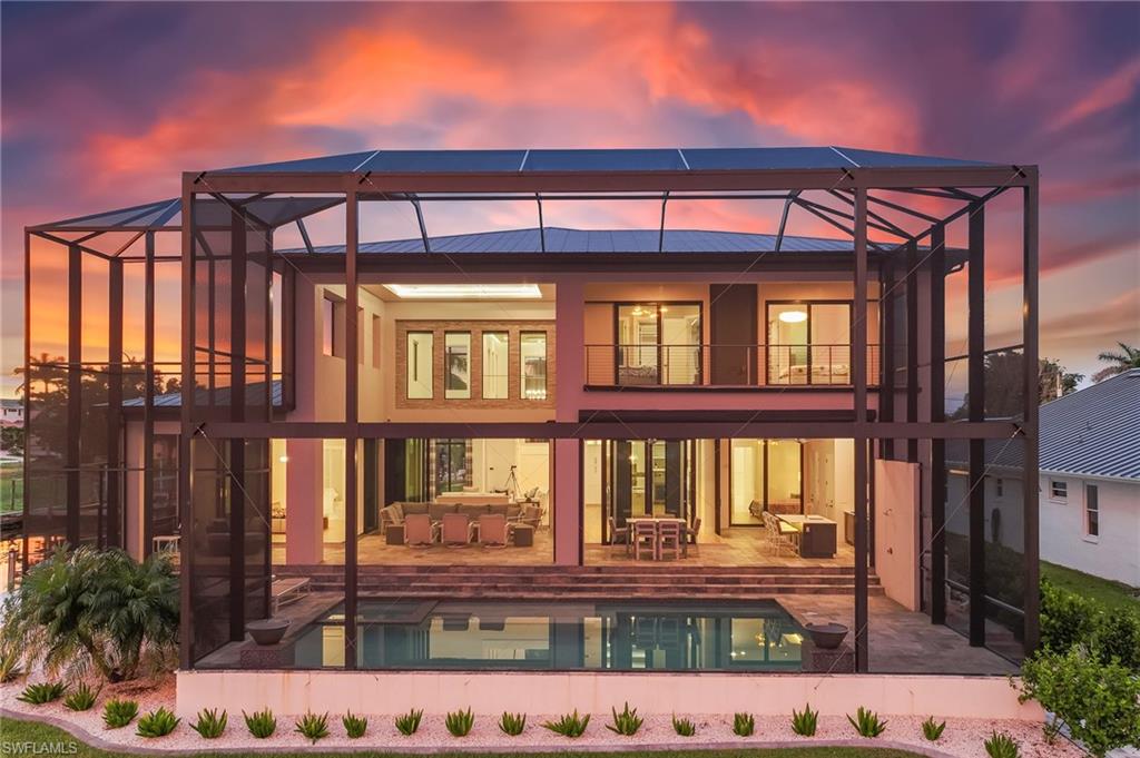 Experience 253 feet of waterfront luxury at its finest with this contemporary 2-story masterpiece, perfectly situated in Cape Coral’s coveted Yacht Club area. Enjoy breathtaking views of a large intersecting canal basin with direct southern exposure to the Caloosahatchee River—offering stunning sunrises, sunsets, and an ever-changing waterscape.

This boater’s dream is ideally located at the end of a quiet cul-de-sac, just a short walk or golf cart ride to Cape Coral’s only beach, the iconic Boathouse restaurant, and the vibrant South Cape district. Designed for those who love the water, the home features two boat lifts: a 16,000-lb lift with a captain’s walk and canopy—perfect for a yacht or larger vessel—and an additional 8,000-lb lift for jet skis or smaller boats. Both are thoughtfully positioned on the side of the property to preserve the home’s spectacular water views.

With over 4,000 sq ft of refined living space and 6,180 sq ft total under truss, this home blends modern elegance with top-tier craftsmanship. The first floor offers a grand owner’s retreat with 90-degree, 10-foot sliders that open seamlessly to the pool area, a spa-like en-suite bath, and a spacious walk-in closet. A second master suite on the opposite side of the home ensures privacy for guests or multigenerational living.

Upstairs, you’ll find two additional bedrooms with en-suite baths and private balconies showcasing panoramic river views, along with a private gym and a spacious entertainment loft with a fireplace.

From its prime boating location to its high-end finishes and expansive design, this property is a rare find for yachting enthusiasts and lovers of coastal luxury. A full list of upgrades and premium features is available upon request.