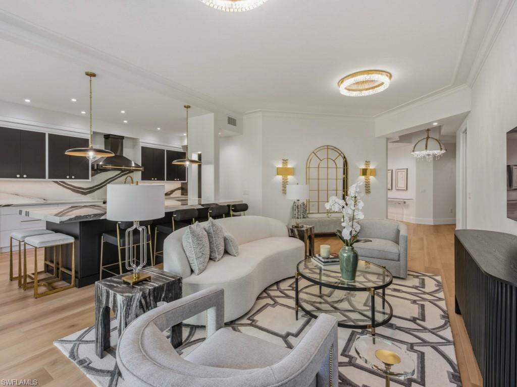 Completely reimagined with an editorial eye for design and a sense of quiet opulence, this extraordinary Olde Naples residence is just minutes from Fifth Avenue South and the Gulf’s white-sand beaches. Reconstructed down to the studs, every inch of the home was thoughtfully curated to create a space that feels both visually stimulating and effortlessly livable, where bold architectural choices, and gallery-like finishes come together in perfect balance. This large 3-bedroom/3.5 bath condo lives like a home and is brimming with natural light beneath soaring ceilings, the open-concept interior unfolds with a striking sense of scale and cohesion. Wide-plank flooring, exceptional sculptural lighting, custom millwork, and dramatic stone selections create a layered aesthetic that is at once modern, warm, and undeniably memorable. At the heart of the home, the showstopping kitchen feels pulled from the pages of a design magazine, appointed with floor-to-ceiling custom cabinetry, brass and crystal hardware, integrated refrigeration, wine storage, an Italian black ILVE range with matching statement hood, and sweeping Italian porcelain surfaces that continue seamlessly from the counters to the backsplash in a bold waterfall effect. The oversized island was designed as both a functional workspace and social centerpiece, comfortably accommodating gathering, conversation, and entertaining alike. The living spaces transition effortlessly onto a spacious private balcony overlooking lush tropical greenery and the beautifully landscaped pool area, creating an atmosphere that feels serene, tucked away, in the heart of Olde Naples. The primary suite serves as a calming sanctuary with direct balcony access, dual walk-in closets, an Allegri Italian crystal chandelier, and a spa-like bath wrapped in marble-inspired surfaces, statement lighting, and curated designer finishes. Each guest suite offers its own distinct personality and en-suite bath, finished with the same level of artistry and attention carried throughout the residence. Further elevating the offering is a highly COVETED PRIVATE POOL CABANA with half bath, offering remarkable flexibility as a lounge, wellness space, office, sunset cocktail room, quiet reading area or entertaining space. Additional highlights include a new HVAC system, redesigned electrical and lighting plan, spacious laundry room with storage, secure semi-private elevator, one-car garage, and also an assigned covered parking space. Located within one of Olde Naples’ most intimate boutique buildings, residents enjoy gated garage entry, a heated pool, grilling area, and an unmatched walkable lifestyle just steps from acclaimed dining, boutique shopping, art galleries, and the vibrant energy that defines downtown Naples. For the buyer who values design as much as destination, this exceptional residence delivers a rare fusion of artistry, privacy, and walkable downtown living in one of Olde Naples’ most coveted settings.