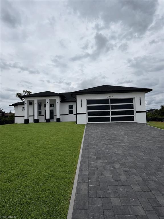Brand-new construction in the final stages of completion and awaiting final Certificate of Occupancy. Be among the first to own this beautifully designed waterfront home. Expected to be move-in ready upon issuance of the final CO.
Welcome to this beautifully designed 4-bedroom + den, 2-bath residence offering modern comfort, quality construction, and waterfront living. Situated on a canal with direct backyard access perfect for kayaking and enjoying the Florida lifestyle, this home combines functionality with elegant finishes throughout.
The open-concept floor plan features a spacious living area that flows seamlessly into the gourmet kitchen, complete with a large center island, double-stacked cabinetry for extra storage, and premium finishes. The split-bedroom layout provides privacy, with a luxurious primary suite featuring dual vanities, a walk-in shower, and generous closet space.Additional highlights include impact-resistant garage door, underground utilities for enhanced reliability and curb appeal, a spacious covered lanai overlooking the canal, and a 2-car garage. Whether you're entertaining guests or enjoying a peaceful waterfront sunset, this home offers the perfect blend of style, comfort, and convenience.