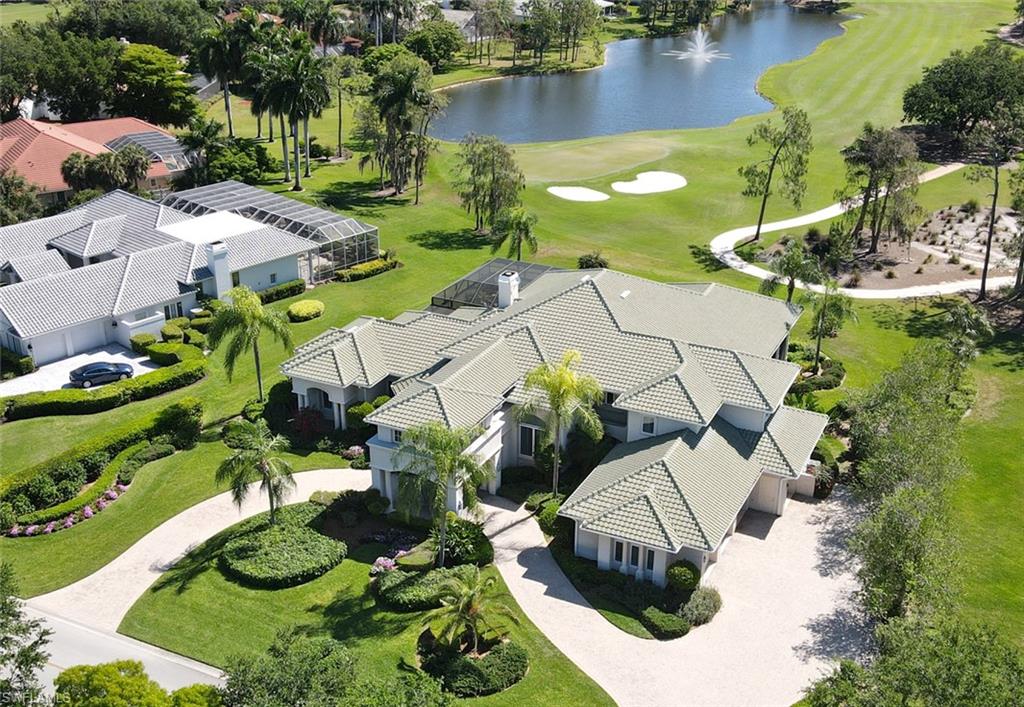 A Rare & Irreplaceable Paradise!  This majestic property offers an opportunity to LIVE in a world all your own.  Drive through the porte cochere to walk through the most impressive front entry.  Truly the most impressive!  
The outdoor area offers a wonderland for golf enthusiasts with a “wow factor” view that spans the long golf course and water highlighted by a special fountain.  The interior offers spectacular attention to detail including the custom iron detailing highlighting the stairway as a true focal point of this HOME, a first-floor sprawling primary retreat and upstairs guest suites with additional private living space.  You will find features both inside and out that offer lush, resort-style living ensuring you will never want to leave this special haven!