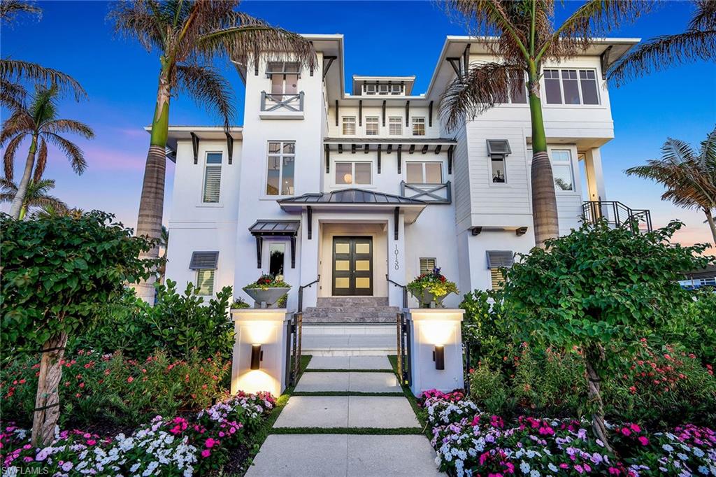 Just a short distance from the pristine sands of Vanderbilt Beach and offering gulf access from your private boat dock, this property provides the ultimate balance of gulf-side serenity and waterfront adventure. Ideally blending with the natural landscape, the entryway flows from the outdoor paved drive to the serene, Zen-like neutral indoor settings. The L-shaped lit, bubbling water feature filled with organic stones adds a must-see element of calm to the exterior. Every detail in this custom-built coastal estate has been thoughtfully curated to embody refined artistry and modern luxury, with a private elevator seamlessly transporting you between all three levels. Legno Bastone hardwood flooring accented with travertine flows throughout, while Venetian plaster walls add timeless elegance to every corner. Custom chandeliers illuminate each space with a touch of grandeur, and soaring volume ceilings create an open, airy ambiance. Every room shines, lavished with luxurious custom finishes that elevate this property into a work of art. From the living room to the dining room and the adjacent radiant backlit quartzite wet bar, an undeniable focal point for entertaining, to the glass-enclosed wine cellar to each bedroom, complete with spacious walk-in closets and spa-like en suites, every space has been meticulously crafted with thoughtful attention to detail. The chef’s kitchen is a masterpiece in its own right, dazzling with Cristallo quartzite waterfall countertops, state-of-the-art Wolf appliances, dual Sub-Zero refrigerators, walk-in pantry and a gas range. The indoors and outdoors blend harmoniously, with oversized glass pocket sliders opening to an exceptional outdoor retreat with a south-facing infinity-edge pool and bubbling spa. The thoughtfully designed outdoor kitchen and seating area are ideal for year-round entertaining, featuring a Wolf grill, a bar and cozy spaces for lounging by the fire features. The lush putting green, bocce court, fire bowls, and fire pits add an extra layer of leisure, making the outdoor spaces as inviting as the interiors, while the fully fenced yard, complete with a keypad gate, ensures privacy and peace of mind. This remarkable property invites you to live the best of both worlds, a beach lover’s paradise and a boater’s dream, where luxury knows no bounds.