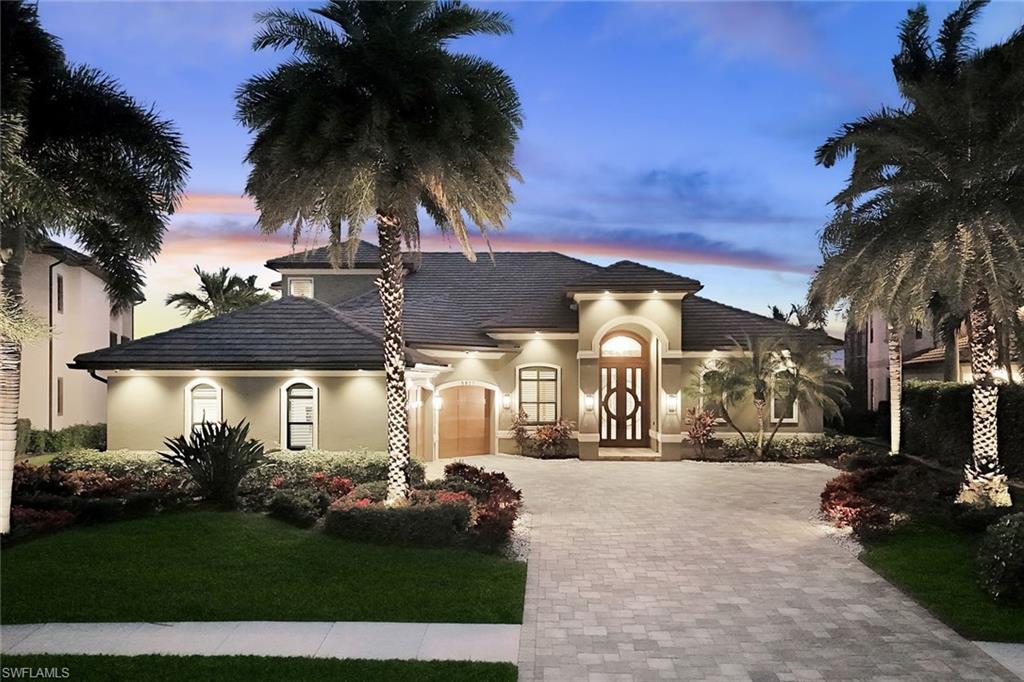 A true Cape Harbour showpiece built by award-winning Aubuchon Homes, offering DEEP WATER SAILBOAT ACCESS, 130’ OF WATER FRONTAGE, and highly desirable SOUTHERN REAR EXPOSURE with wide canal and preserve views. Designed for boating, entertaining, and effortless indoor-outdoor living, this custom estate delivers exceptional quality and lifestyle. This home was built "High & Dry" and had NO WATER PENETRATION or flooding during Hurricanes Ian, Milton, or Helene!

Spanning 4,135 sq ft, the home features 4 bedrooms, 4.5 baths, plus a den/study. The primary suite and two guest ensuites are located on the main level, with a private upstairs guest retreat, full bath, and expansive media room with kitchenette and balcony overlooking the pool, canal, preserve, and evening city lights. Wood plank tile runs throughout the first floor, complemented by high ceilings, impact-resistant windows and doors, central vacuum, and automated sheer daytime and blackout evening shades in select living areas.

The great room features coffered ceilings, fireplace, and 90-degree pocketing sliders that fully open to the screened lanai and pool area. The dining space is positioned between the great room and kitchen and includes its own pocketing sliders for seamless entertaining.

The kitchen is generously sized and thoughtfully designed with custom wood cabinetry, quartz countertops, Sub-Zero refrigerator, Wolf gas range with pot filler, Advantium oven, wall oven, stand-alone ice maker, beverage cooler, large wine refrigerator, walk-in pantry, built-in casual dining table, and a dedicated beverage and serving area ideal for entertaining.

The primary suite offers direct lanai access, two custom walk-in closets, a safe, AV closet, and a spa-inspired bath with dual vanities, makeup vanity, soaking tub, and a large walk-in shower with multiple shower heads.

Outdoor living shines with a 2024 two-story screened enclosure, electric roll-down storm screens, summer kitchen with built-in grill, bar, beverage cooler, covered dining area, heated saltwater pool ideal for lap swimming, integrated spa, sun shelf with fire bowls, and outdoor shower.

At the dock, enjoy a captain’s walk, tiki hut, 10,000 lb. boat lift, and approximately 70’ of additional dockage along the seawall, accommodating larger vessels or sailboats. Additional features include a 2023 roof, buried 500-gallon propane tank supporting the range, grill, fire bowls, and whole-home generator, whole-house carbon water filtration system, and a 3-car garage with mini-split A/C.

Located behind the gates of Cape Harbour with quick boating access to open water, the Gulf of Mexico, and waterfront dining at Cape Harbour and Tarpon Point.